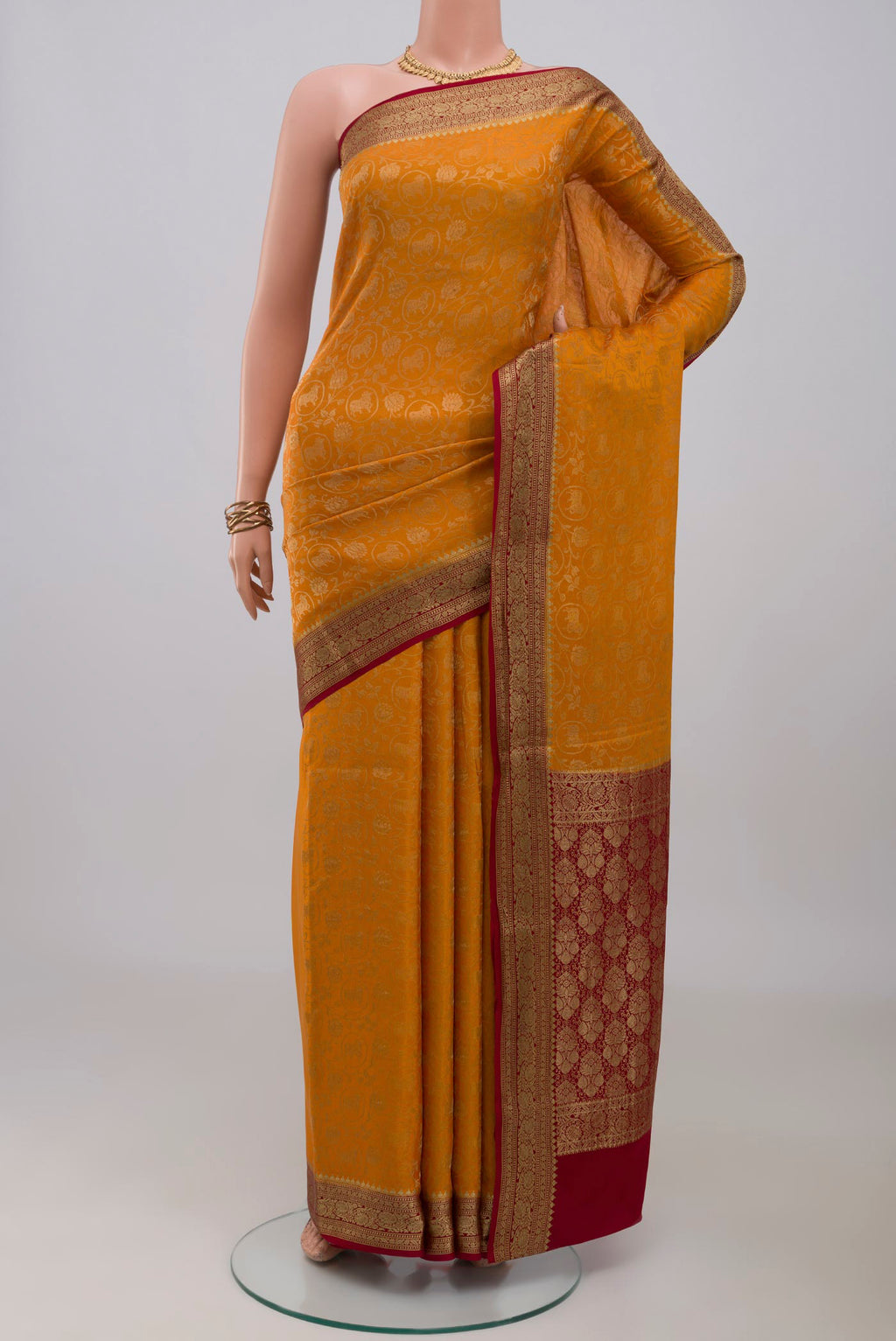 Mustard Mysore Crepe Saree with Zari Brocade on the body and Zari Border.  displayed on a mannequin