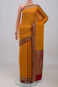 Mustard Mysore Crepe Saree with Zari Brocade on the body and Zari Border.  displayed on a mannequin