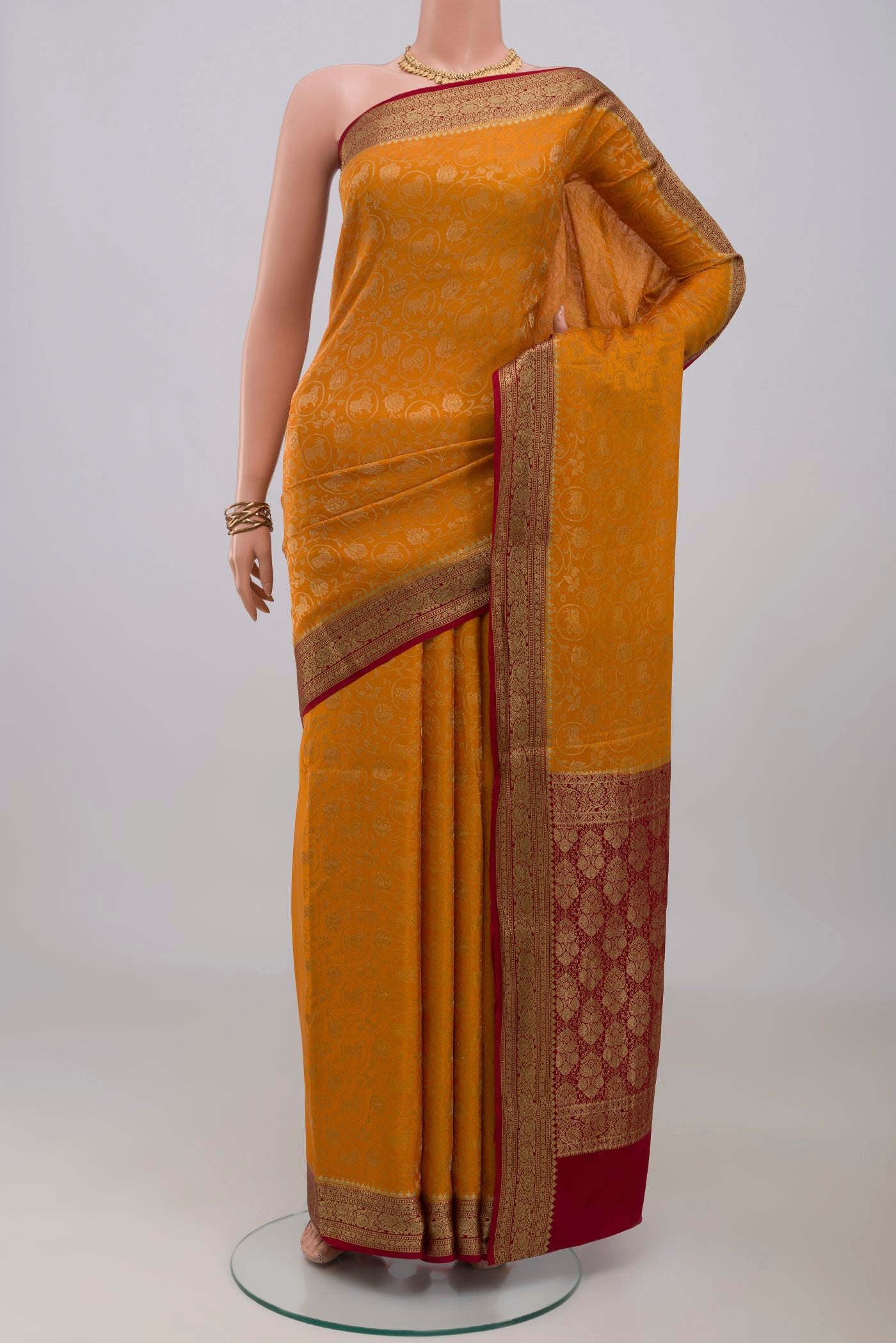 Mustard Mysore Crepe Saree with Zari Brocade on the body and Zari Border.  displayed on a mannequin
