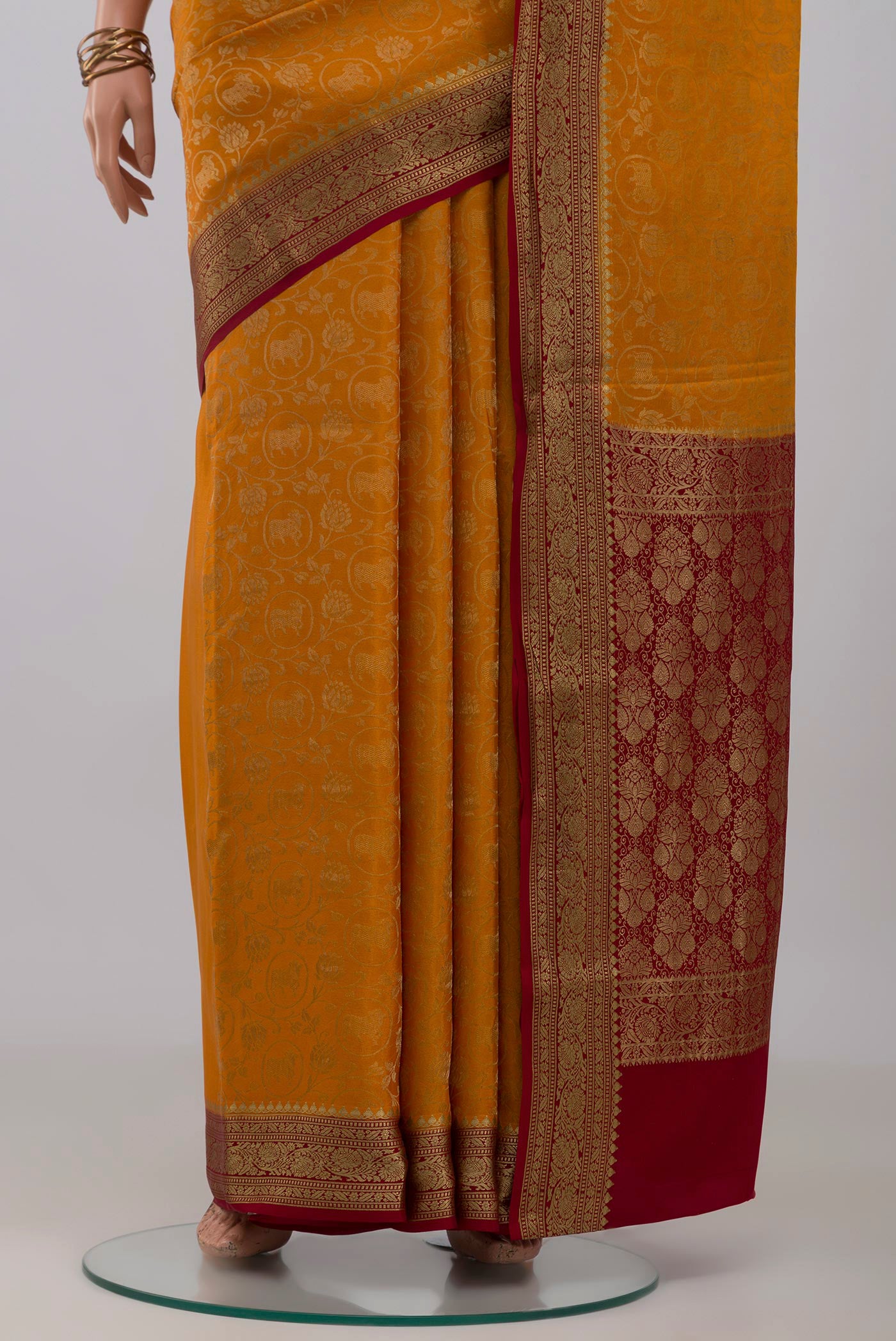 Pleats and pallu of Mustard Mysore Crepe Saree with Zari Brocade on the body and Zari Border. 