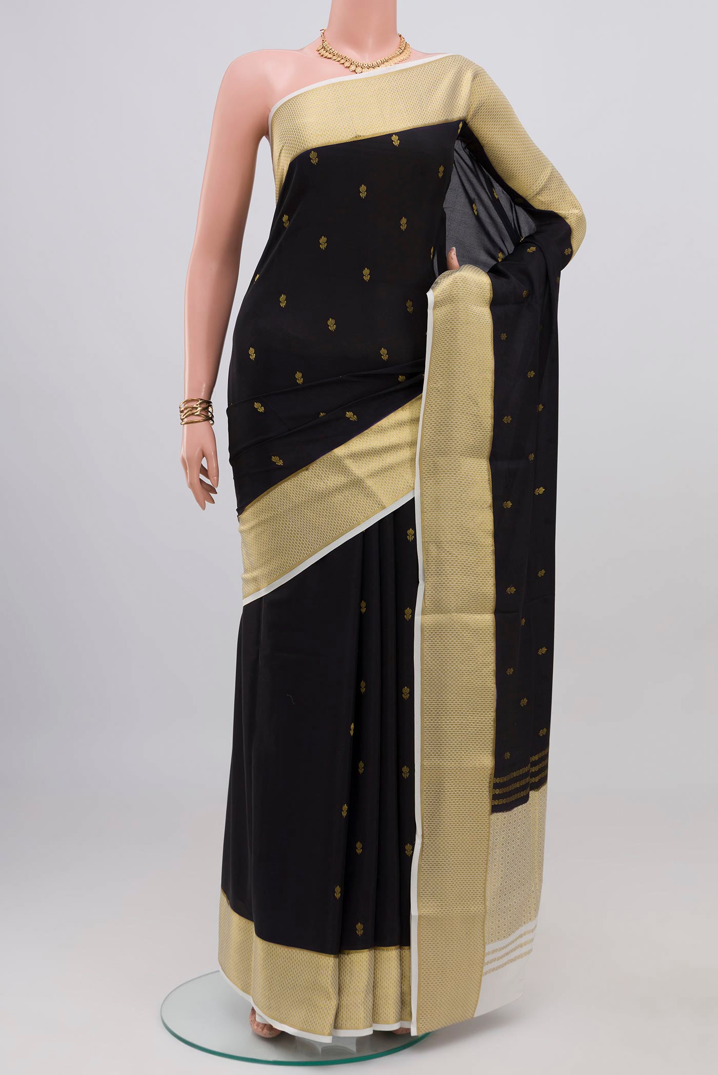 Black Mysore Crepe Saree with Zari Butta on the body and Zari Border.  displayed on a mannequin