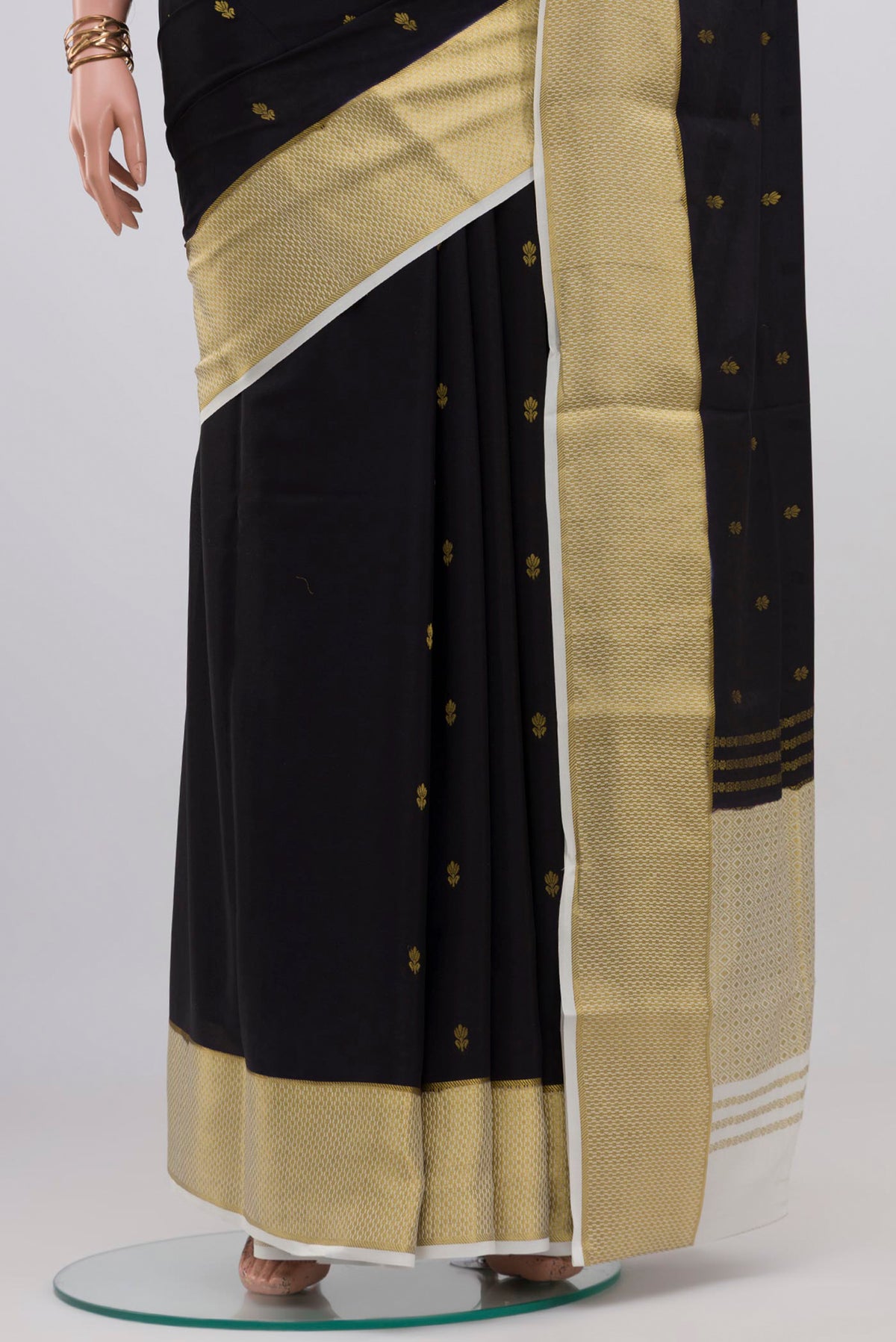 Pleats and pallu of Black Mysore Crepe Saree with Zari Butta on the body and Zari Border. 