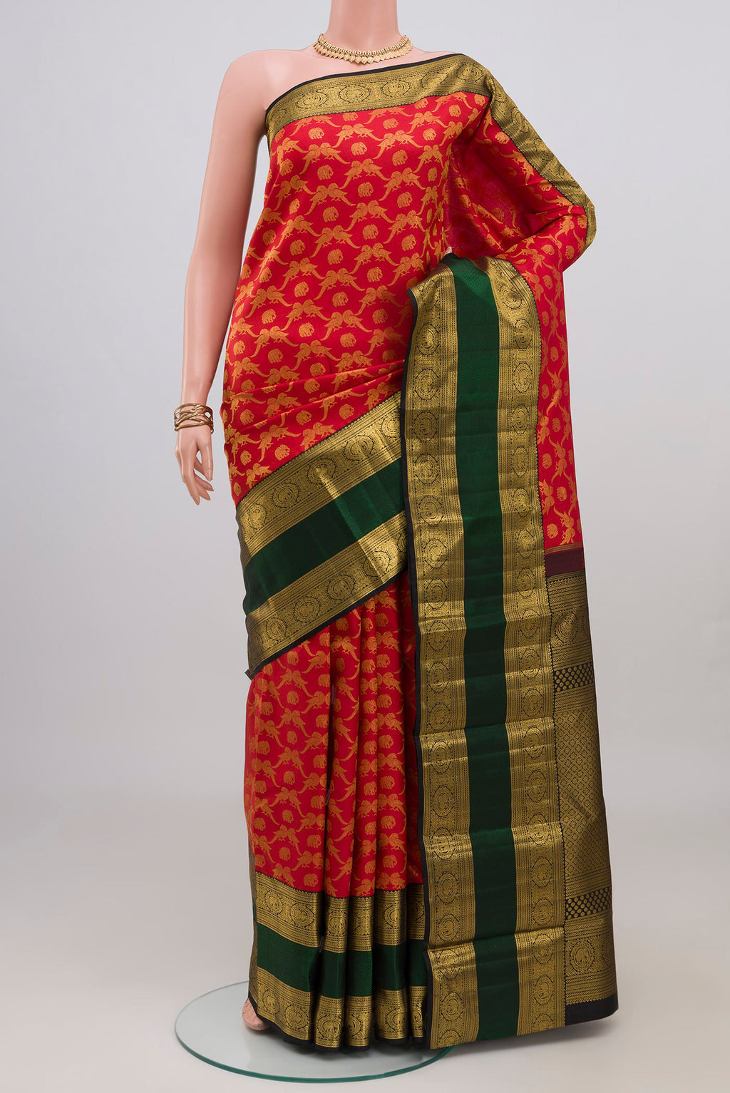 Red Kanchipuram Silk Saree with Zari Brocade on the body and Zari Border.  displayed on a mannequin
