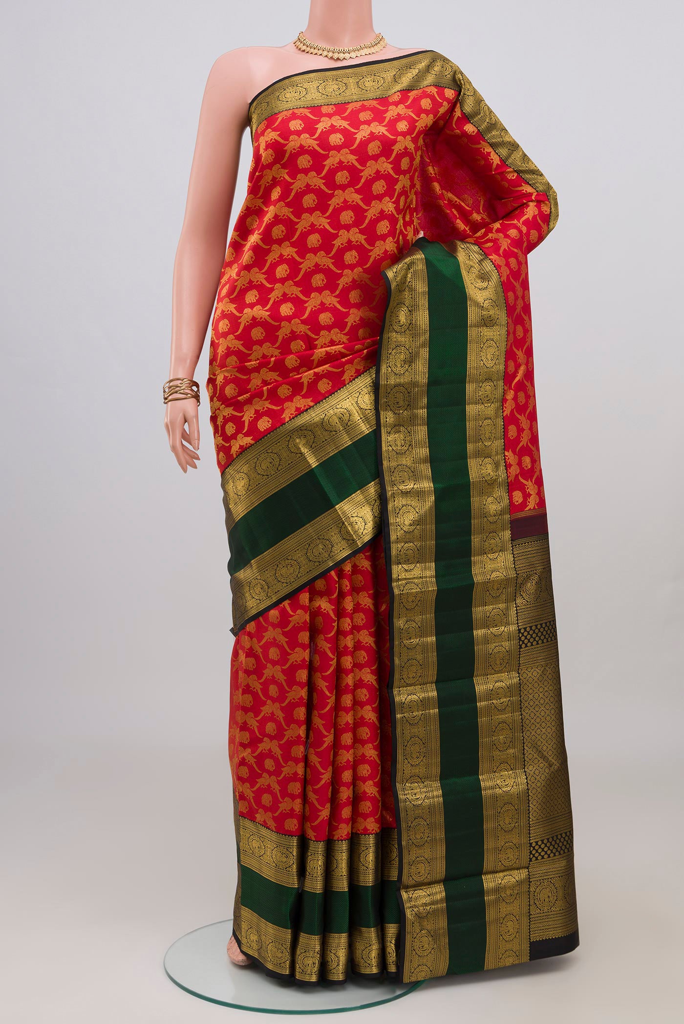 Red Kanchipuram Silk Saree with Zari Brocade on the body and Zari Border.  displayed on a mannequin
