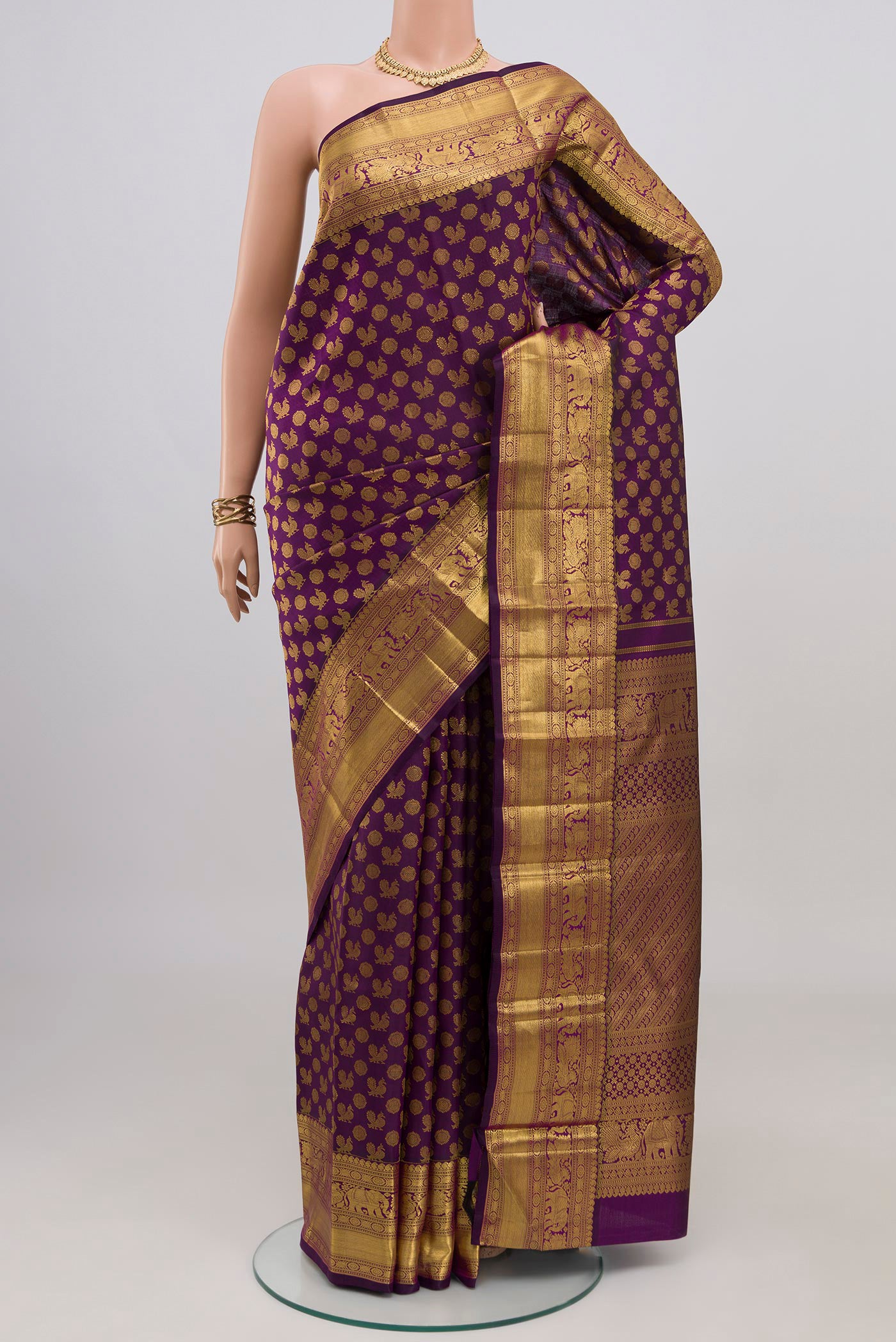 Purple Kanchipuram Silk Saree with Zari Brocade on the body and Zari Border.  displayed on a mannequin
