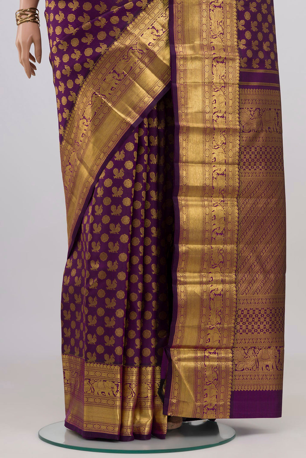 Pleats and pallu of Purple Kanchipuram Silk Saree with Zari Brocade on the body and Zari Border. 
