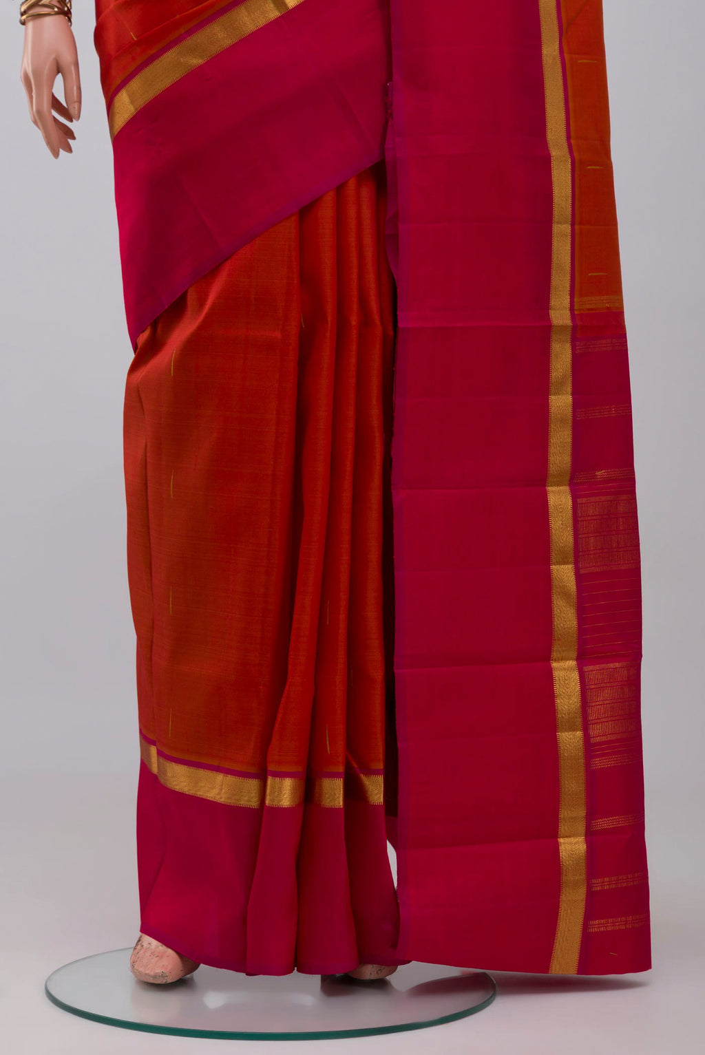 Pleats and pallu of Brick Orange Kanjivaram Silk Saree with Zari Butta on the body and Zari Border. 