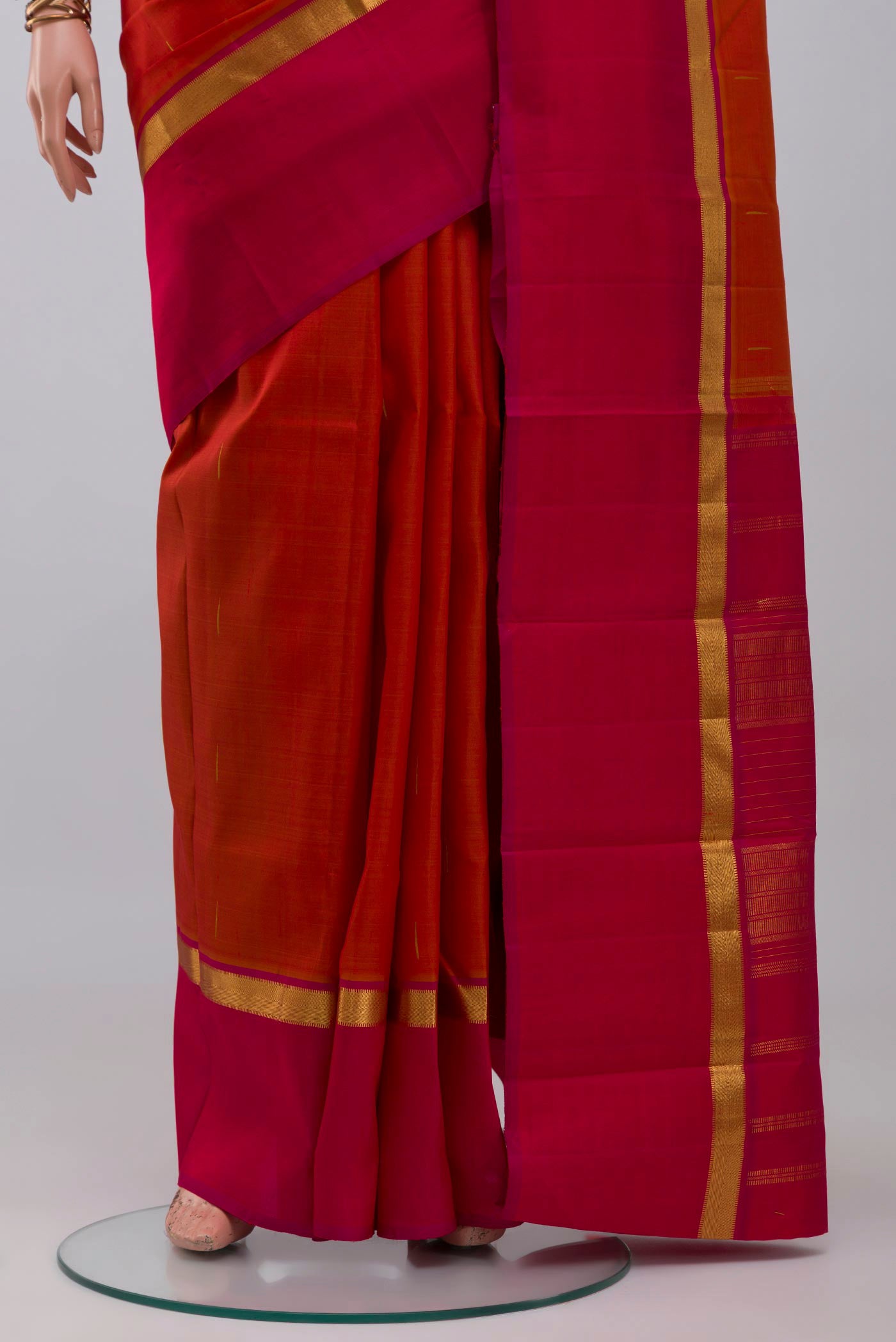 Pleats and pallu of Brick Orange Kanjivaram Silk Saree with Zari Butta on the body and Zari Border. 