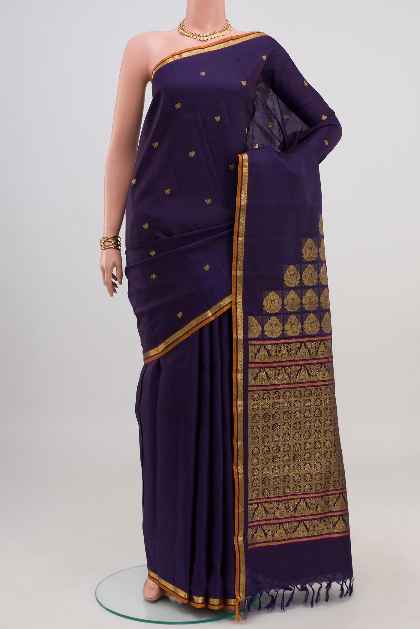 Navy Blue Kanjivaram Silk Saree with Zari Butta on the body and Thin Zari Line.  displayed on a mannequin