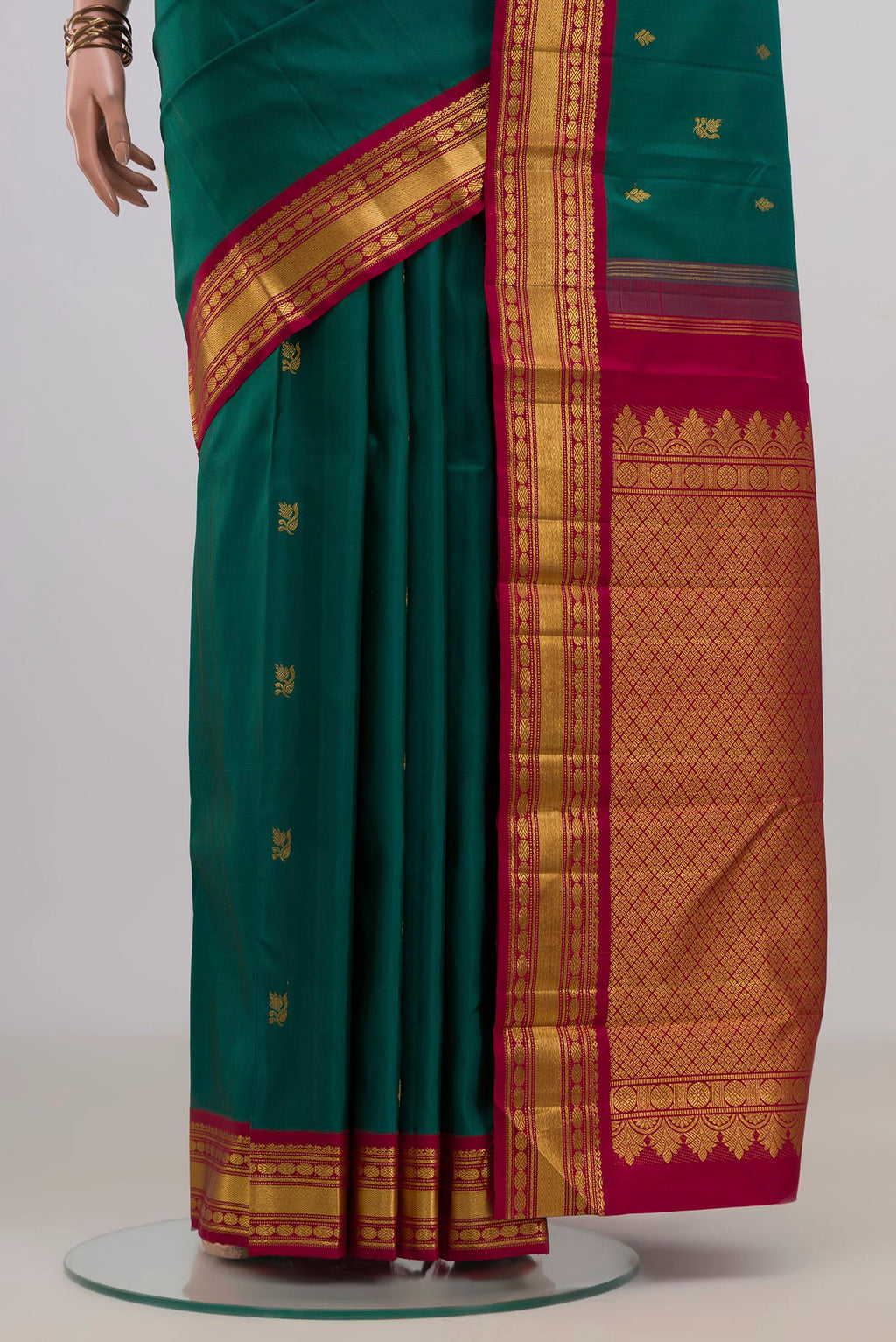 Pleats and pallu of Pure Silk Green Kanchipuram Saree with Zari Butta on the body and Zari Border. 