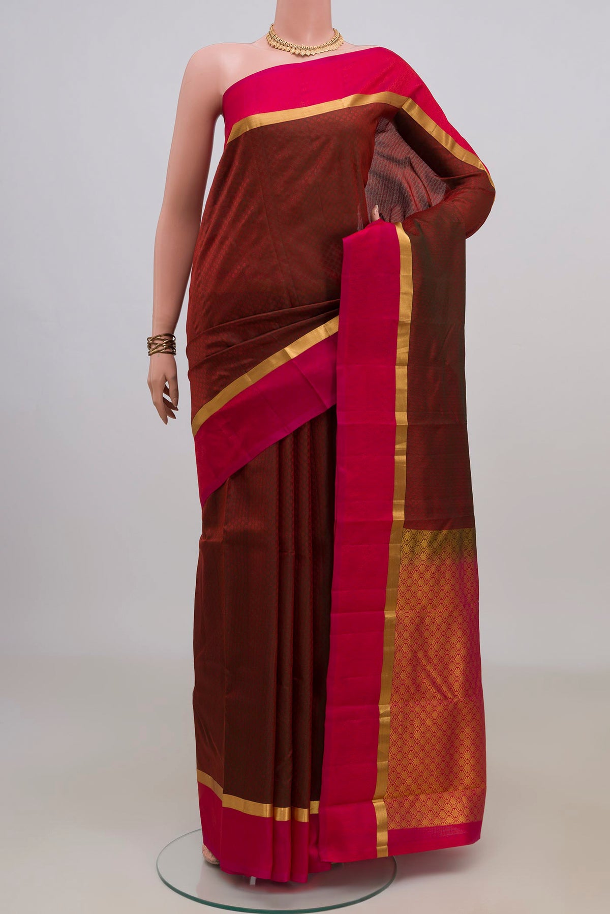 Pure Silk Maroon Kanjivaram Saree with Jacquard design on the body and Thin Zari Line.  displayed on a mannequin