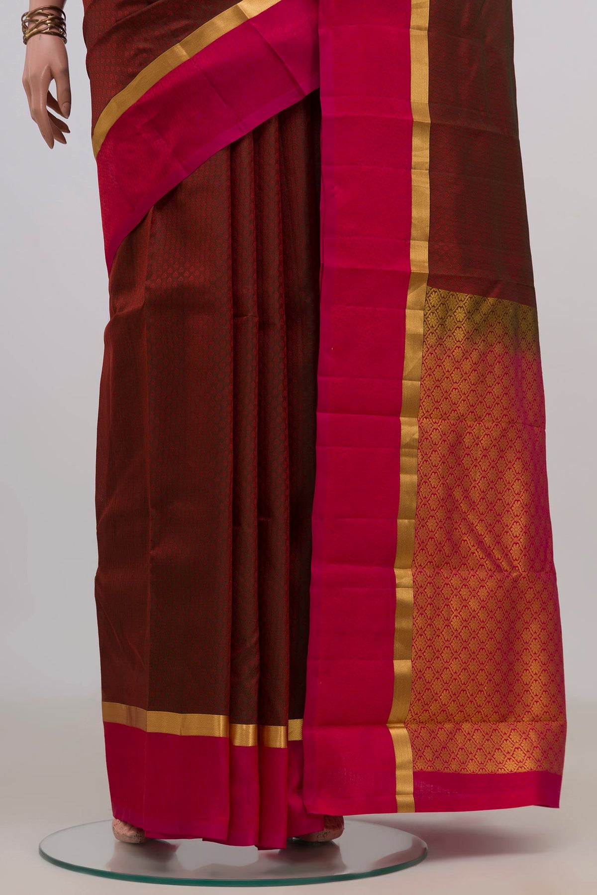 Pleats and pallu of Pure Silk Maroon Kanjivaram Saree with Jacquard design on the body and Thin Zari Line. 