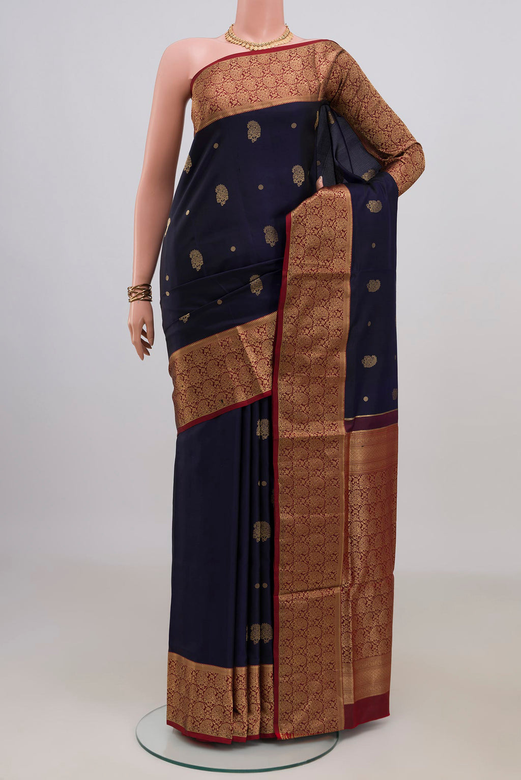 Pure Silk Navy Blue Soft Saree with Zari Butta on the body and Zari Border.  displayed on a mannequin