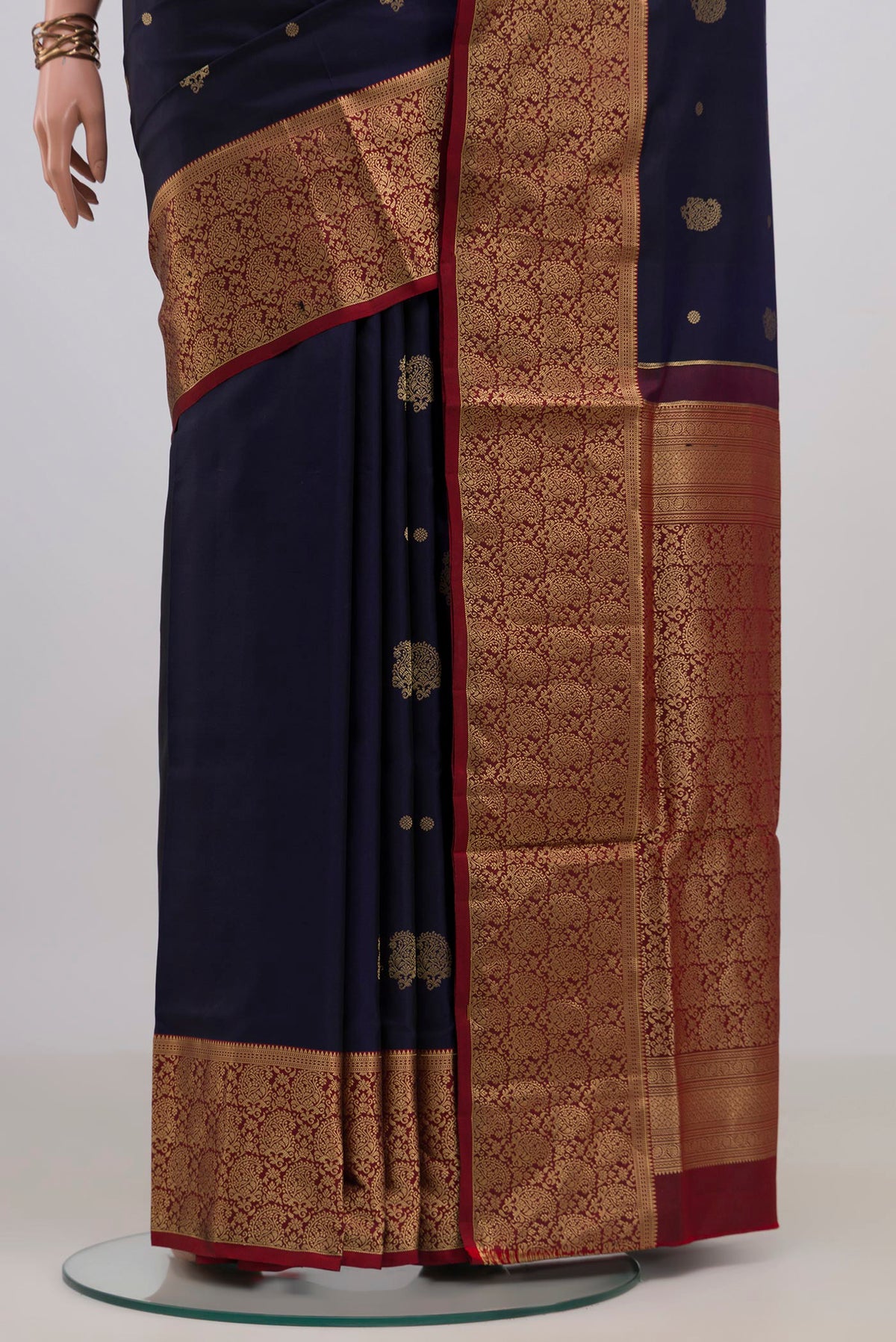 Pleats and pallu of Pure Silk Navy Blue Soft Saree with Zari Butta on the body and Zari Border. 