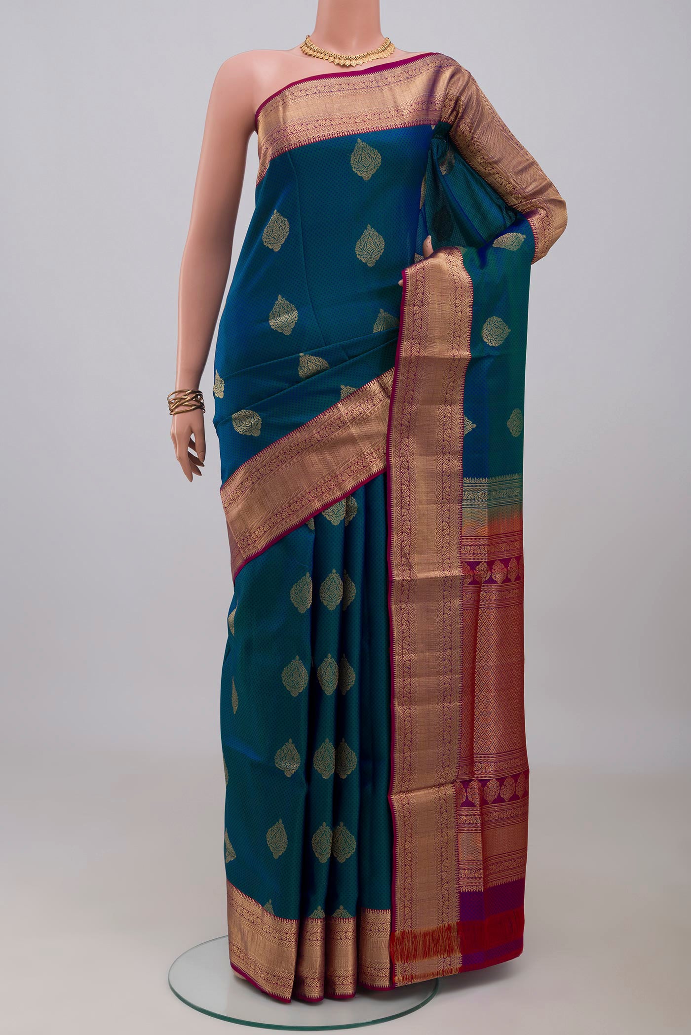 Peacock Blue Soft Silk Saree with Jacquard With Zari Butta on the body and Zari Border.  displayed on a mannequin