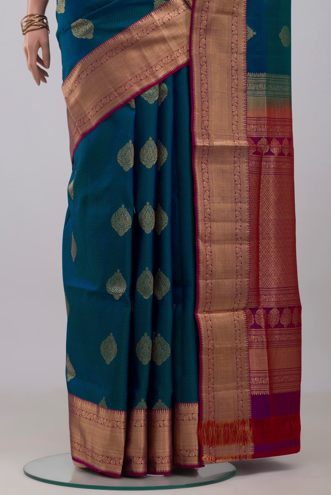 Pleats and pallu of Peacock Blue Soft Silk Saree with Jacquard With Zari Butta on the body and Zari Border. 