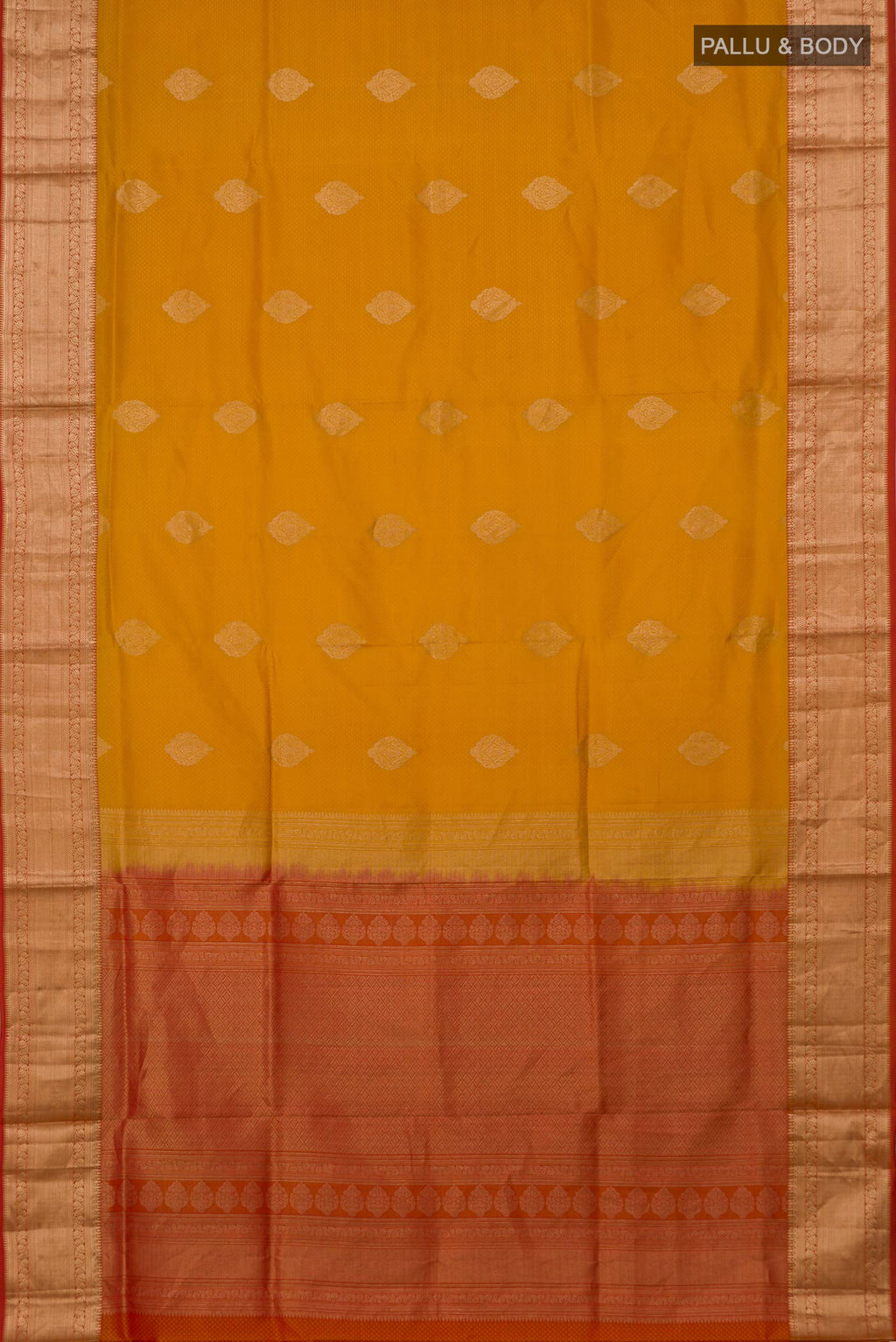 Flat view of Mustard Soft Silk Saree with Zari Butta on the body and Zari Border. 