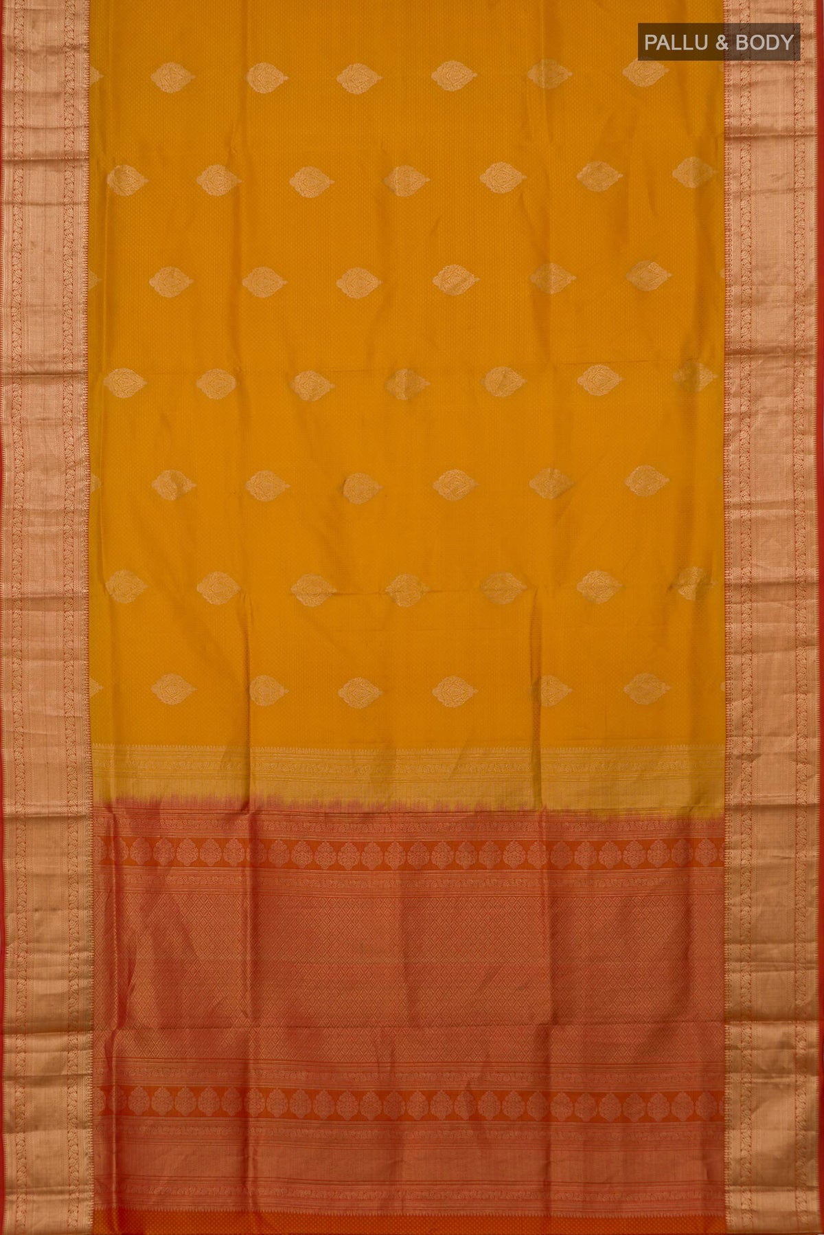 Flat view of Mustard Soft Silk Saree with Zari Butta on the body and Zari Border. 