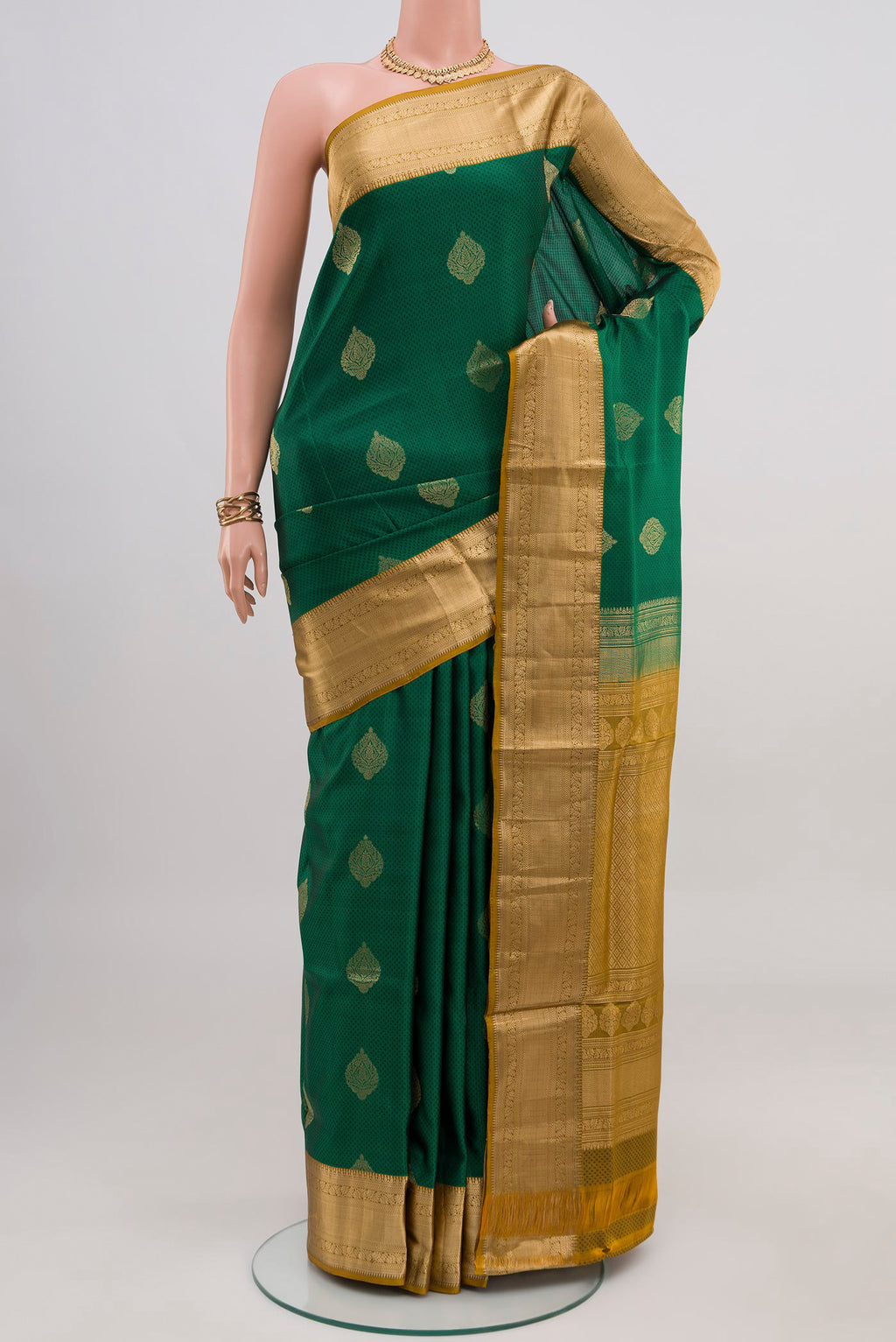 Green Soft Silk Saree with Jacquard With Zari Butta on the body and Zari Border.  displayed on a mannequin