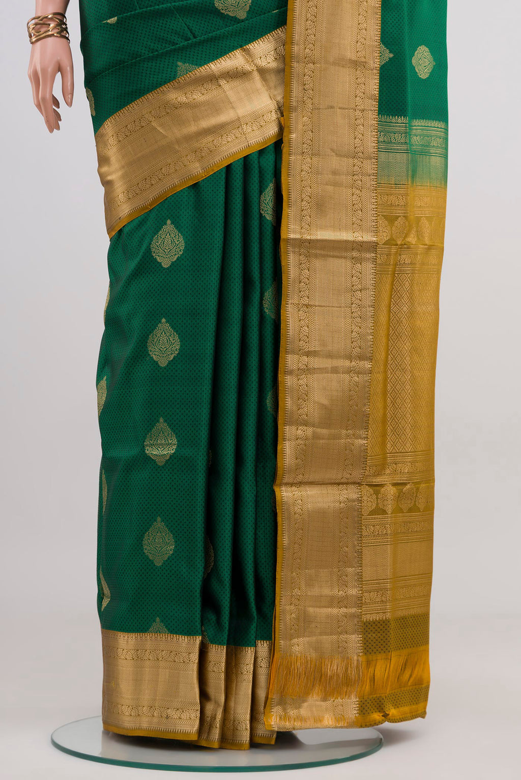 Pleats and pallu of Green Soft Silk Saree with Jacquard With Zari Butta on the body and Zari Border. 