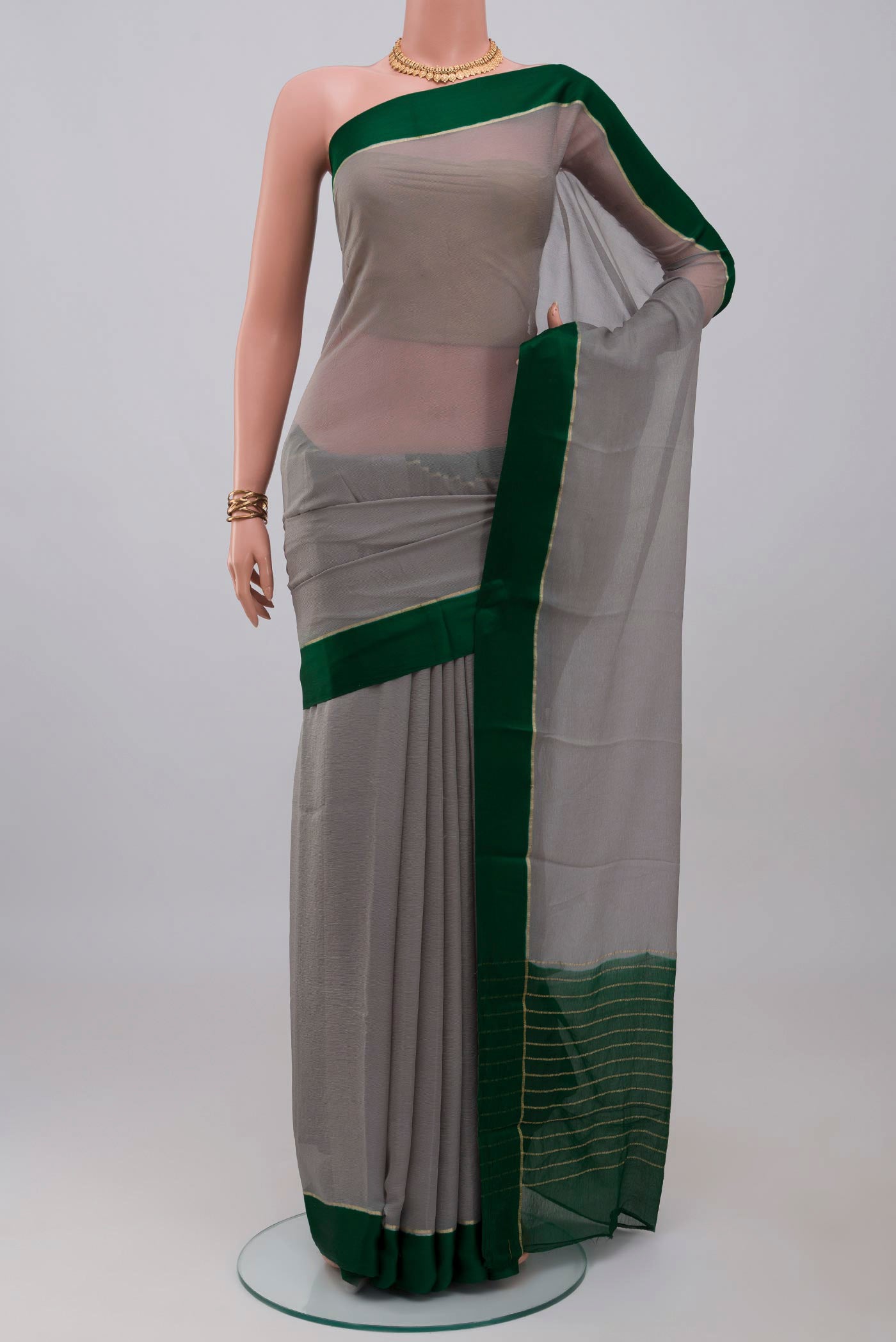 Grey Mysore Chiffon Saree with Plain Body and Thin Zari Line.  displayed on a mannequin