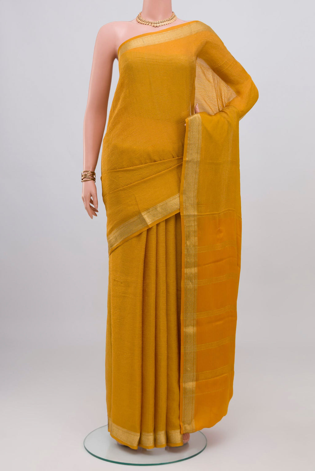 Mustard Mysore Georgette Saree with Plain Body and Zari Border.  displayed on a mannequin