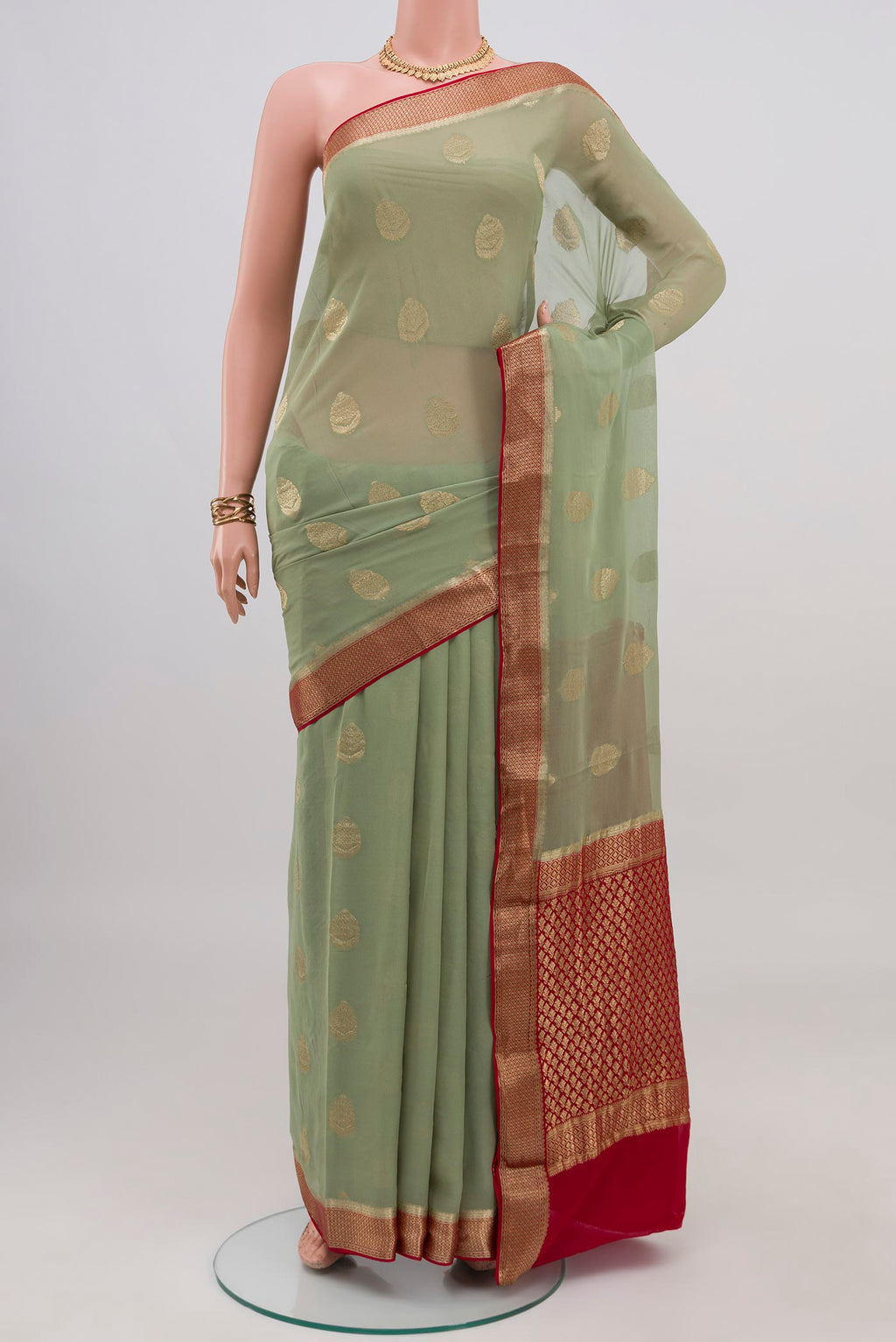 Pista Green Mysore Georgette Saree with Zari Butta on the body and Zari Border.  displayed on a mannequin