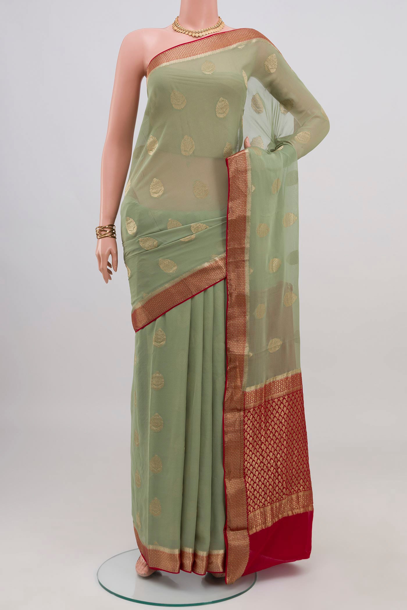 Pista Green Mysore Georgette Saree with Zari Butta on the body and Zari Border.  displayed on a mannequin