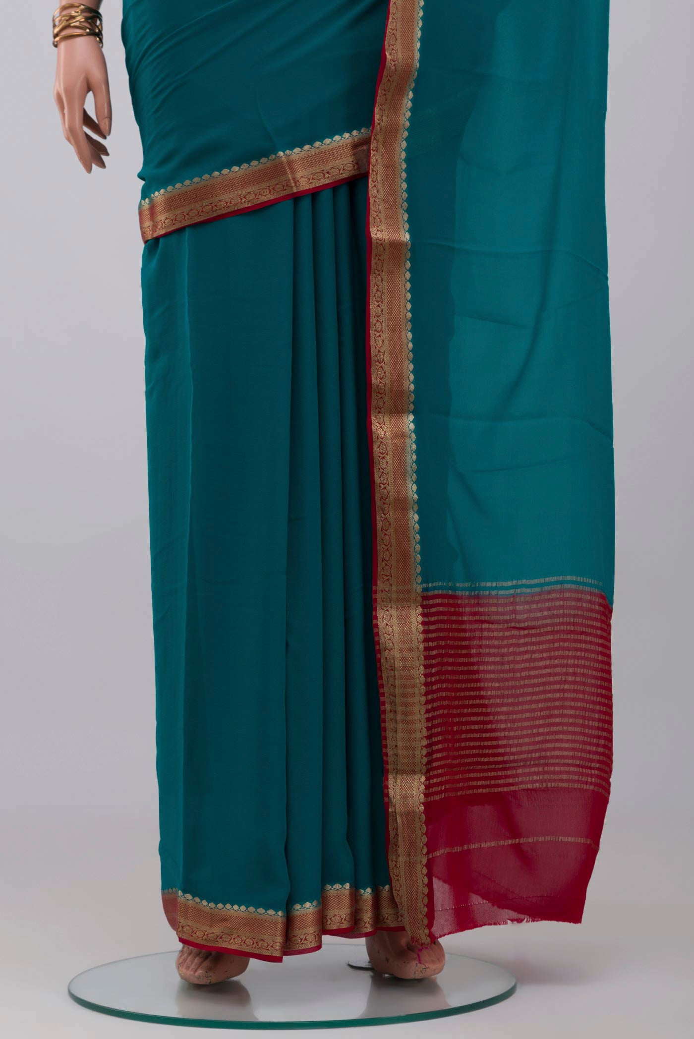 Pleats and pallu of Blue Mysore Georgette Saree with Plain Body and Zari Border. 