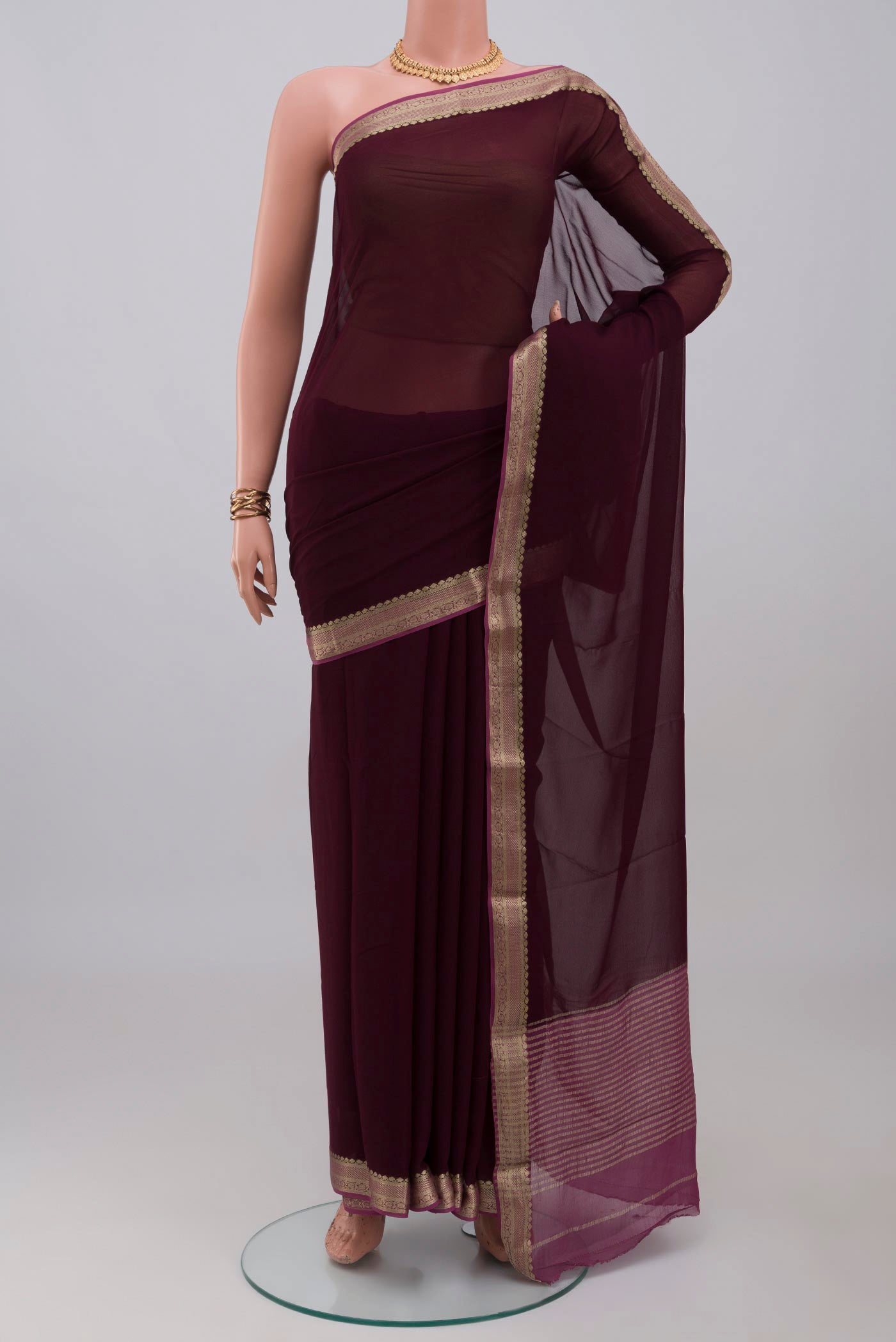 Coffee Brown Mysore Georgette Saree with Plain Body and Zari Border.  displayed on a mannequin