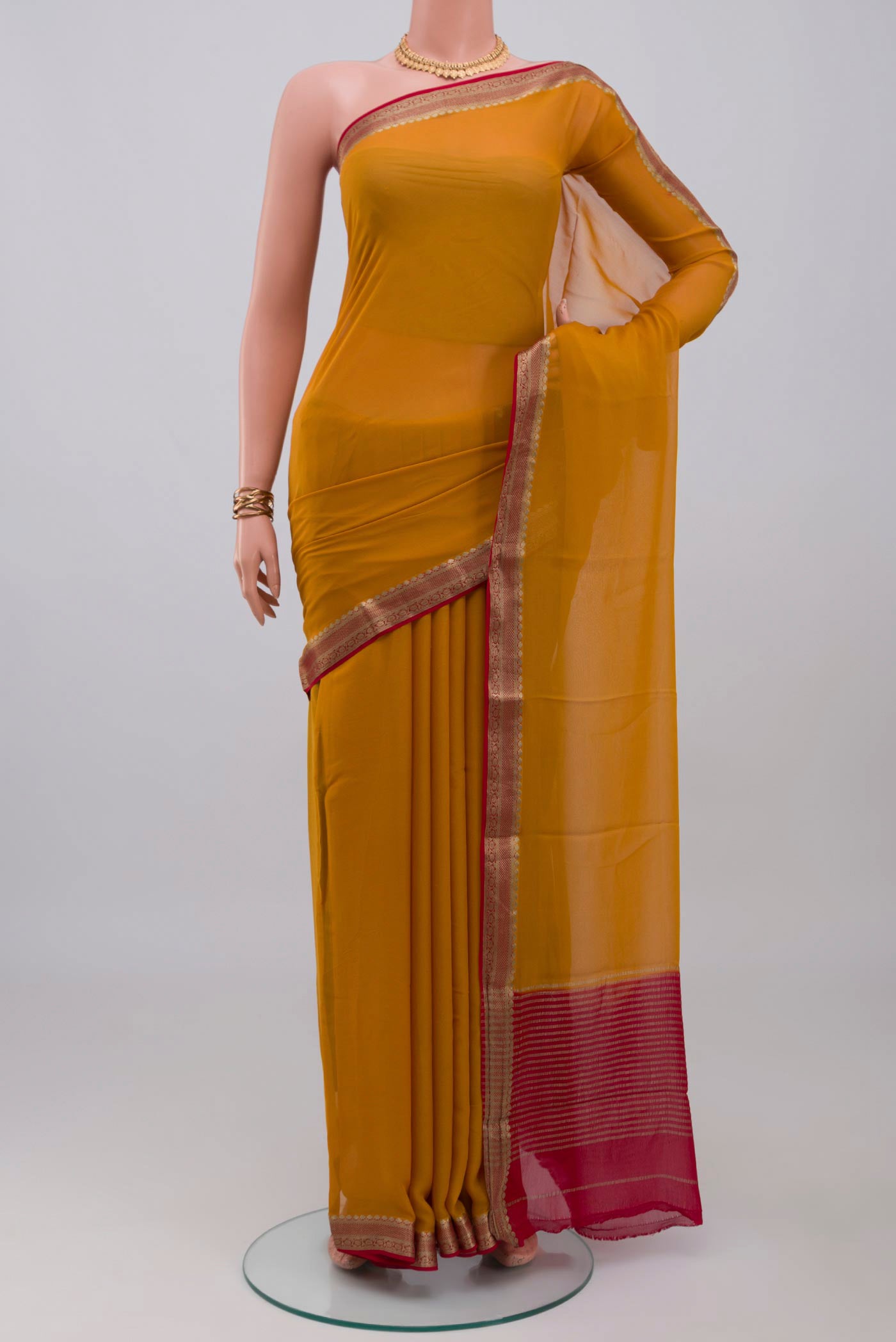Mustard Mysore Georgette Saree with Plain Body and Zari Border.  displayed on a mannequin