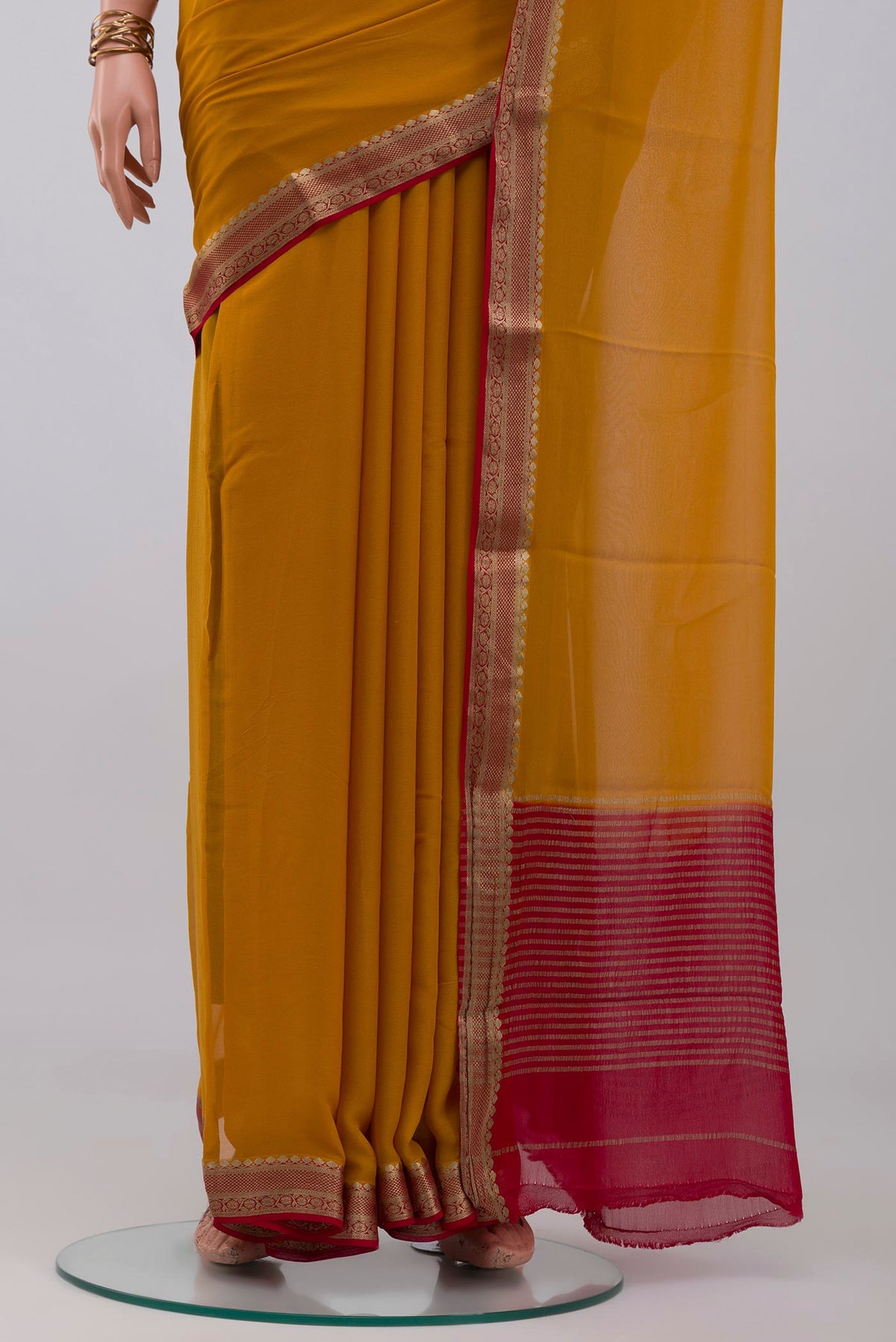 Pleats and pallu of Mustard Mysore Georgette Saree with Plain Body and Zari Border. 