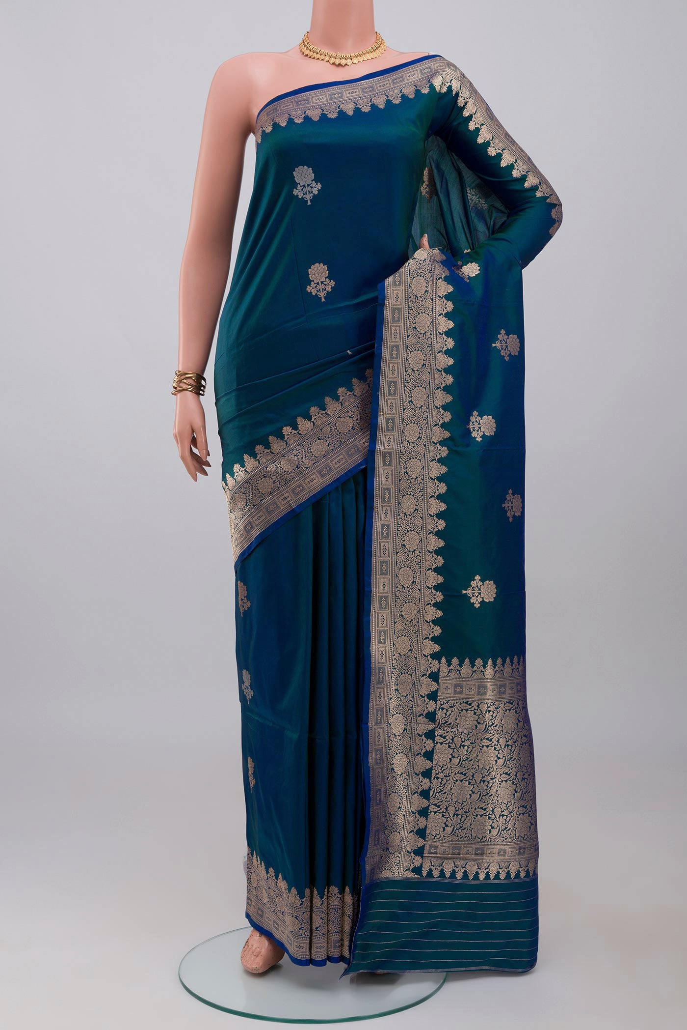 Blue Banarasi Katan Silk Saree with Zari Butta on the body and Zari Border.  displayed on a mannequin