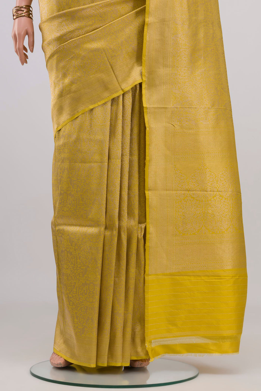 Pleats and pallu of Yellow Banarasi Katan Silk Saree with Zari Brocade on the body and Fancy Border. 