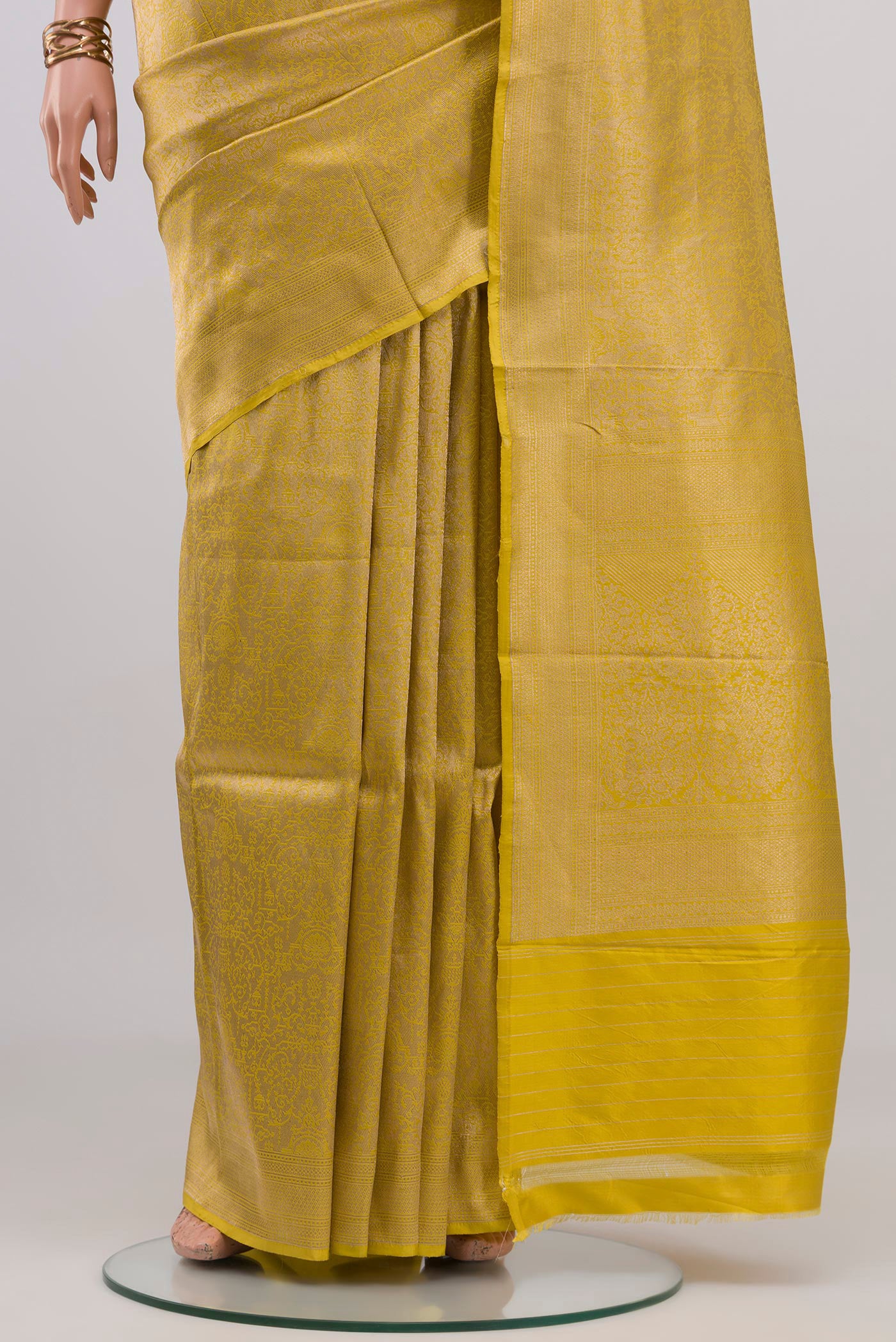 Pleats and pallu of Yellow Banarasi Katan Silk Saree with Zari Brocade on the body and Fancy Border. 