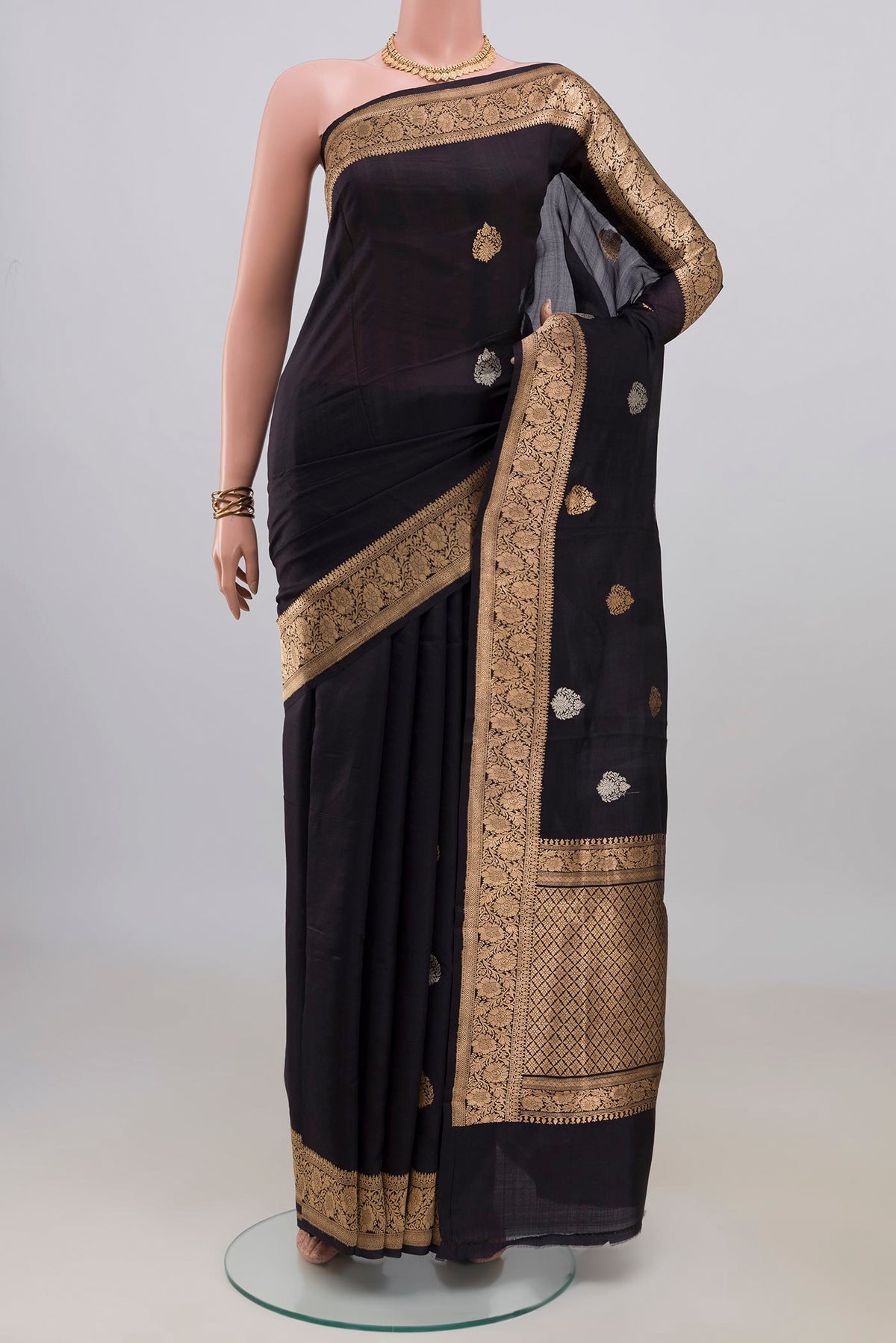 Pure Silk Black Banarasi Katan Saree with Zari Butta on the body and Zari Border.  displayed on a mannequin