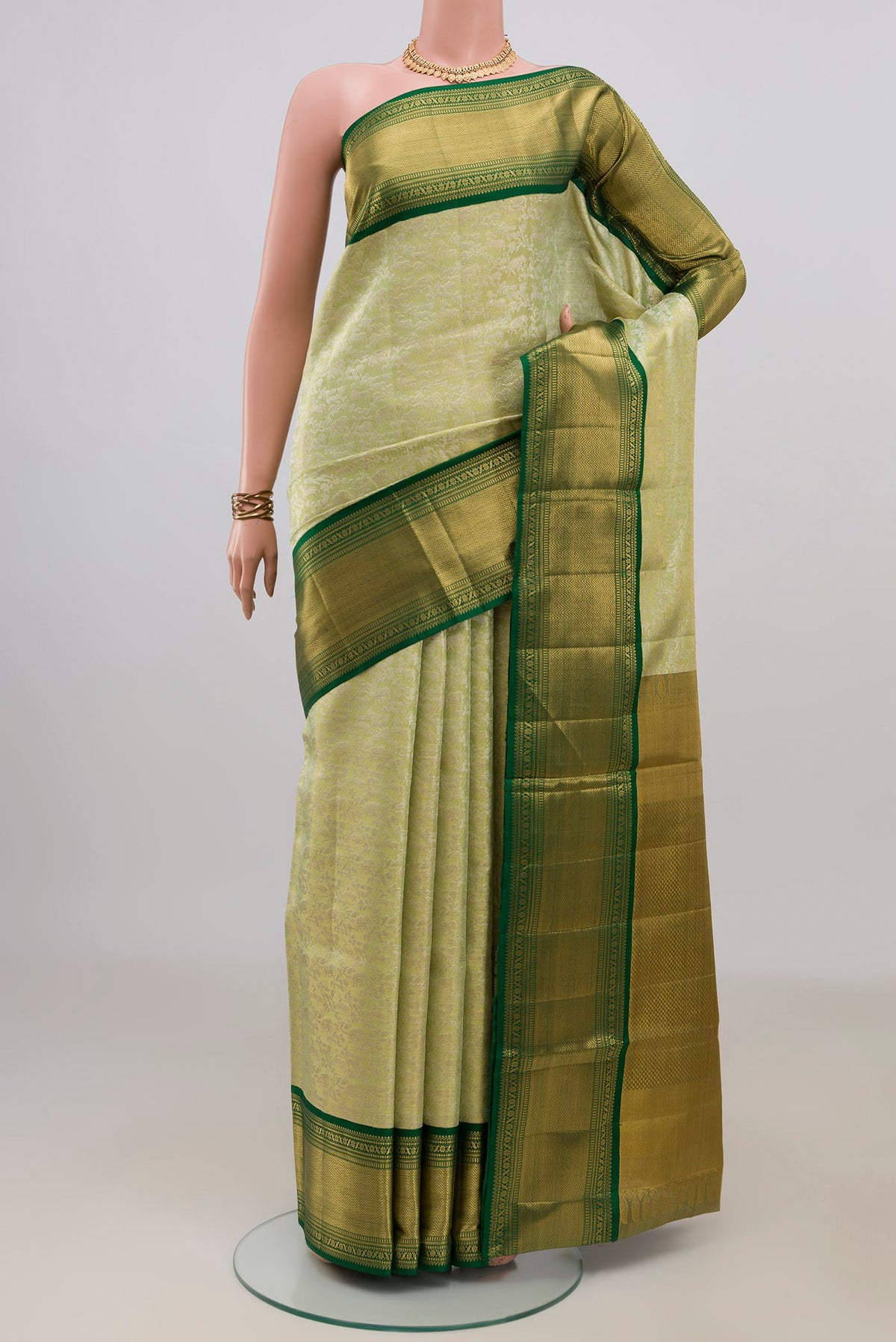 Pista Green Kanjivaram Tissue Saree with Zari Brocade on the body and Zari Border.  displayed on a mannequin