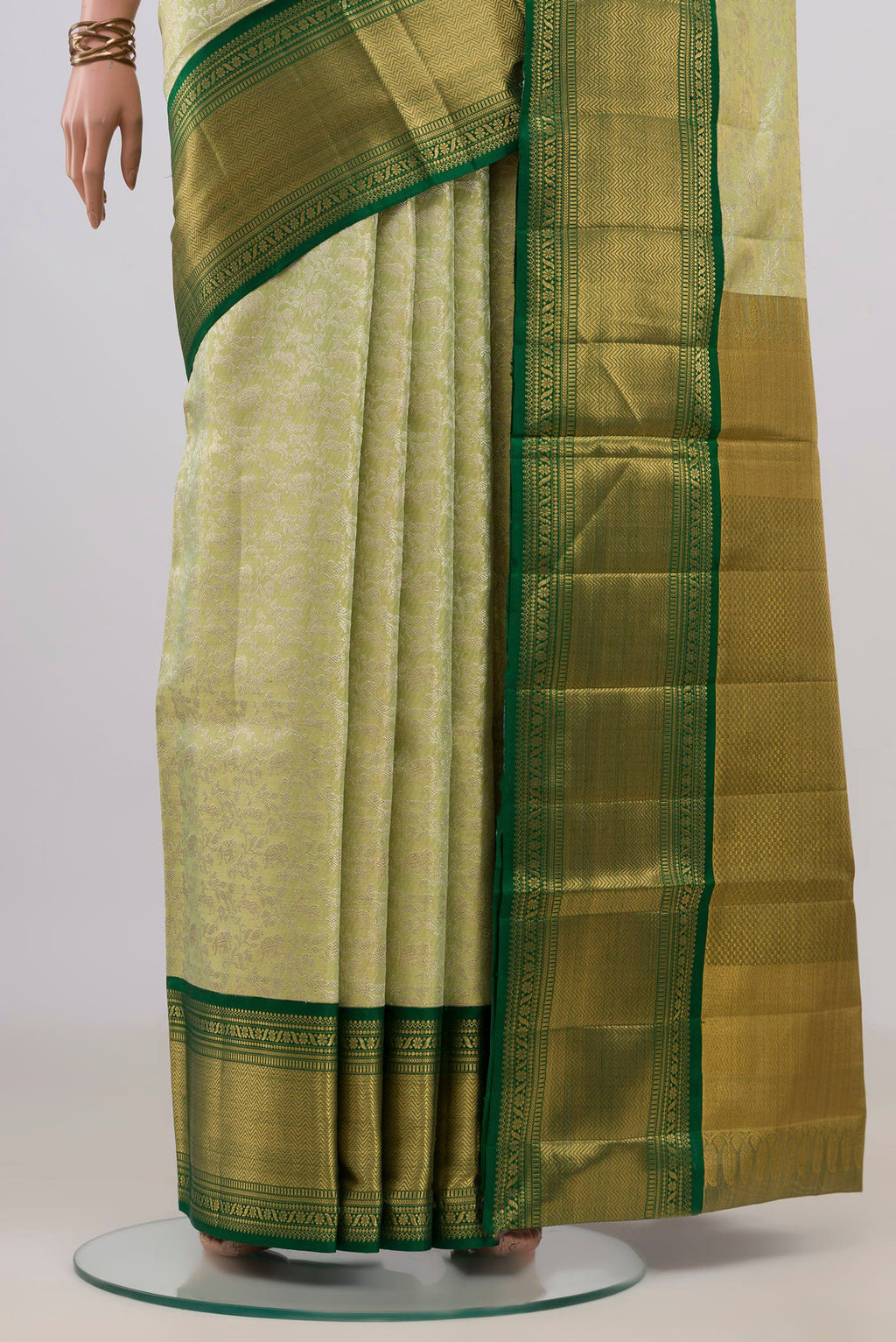 Pleats and pallu of Pista Green Kanjivaram Tissue Saree with Zari Brocade on the body and Zari Border. 