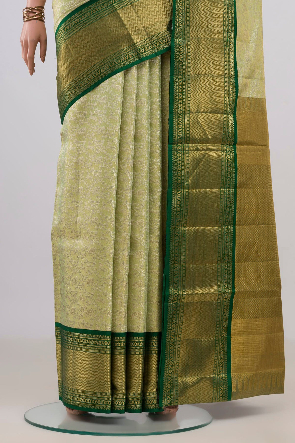 Pleats and pallu of Pista Green Kanjivaram Tissue Saree with Zari Brocade on the body and Zari Border. 