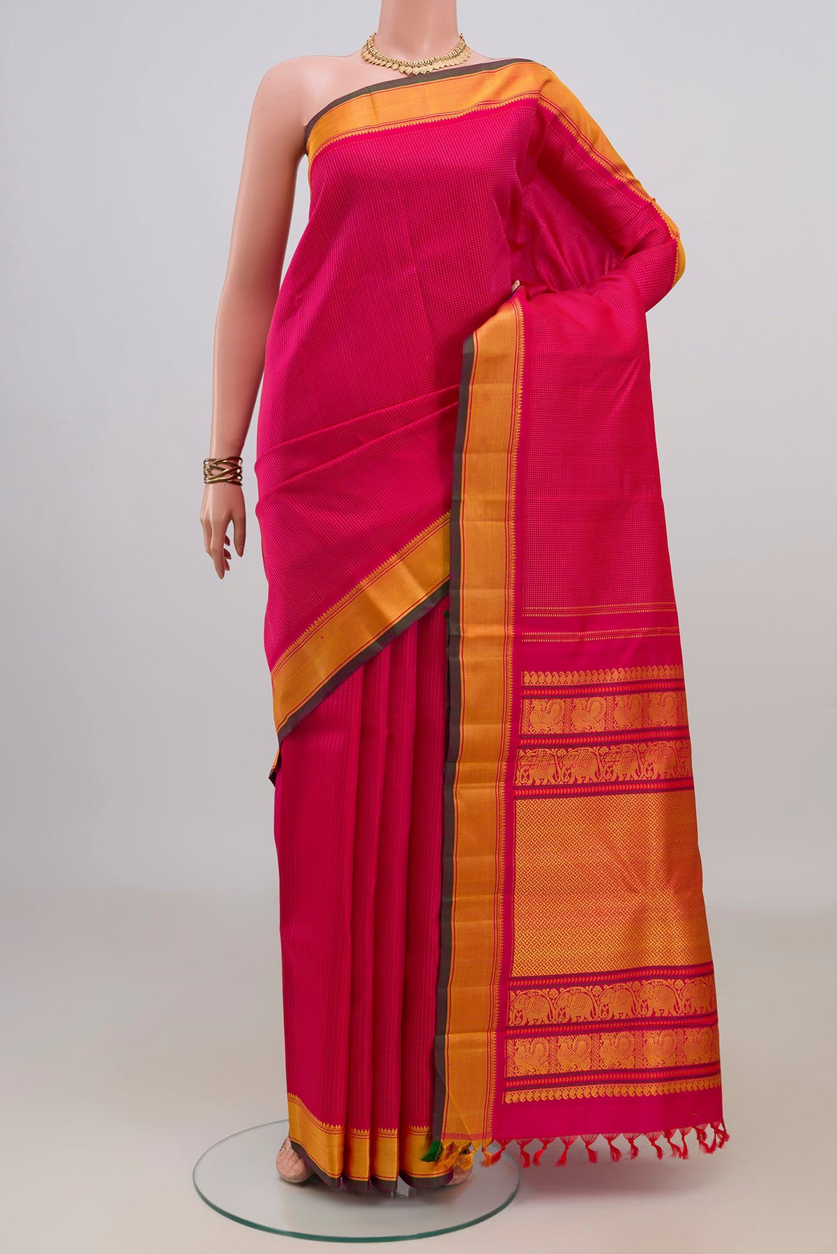 Pure Silk Pink Kanjivaram Saree with Thread Butta on the body and Thread Border.  displayed on a mannequin