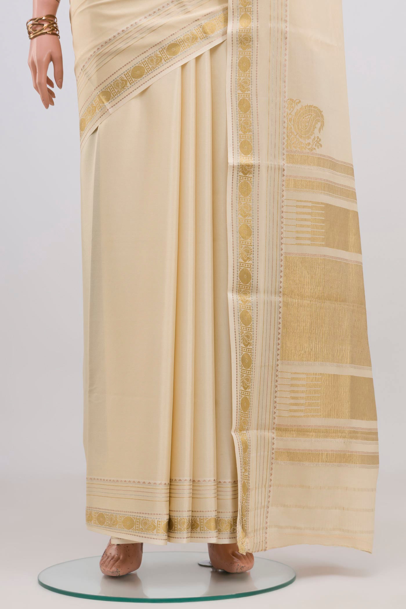 Pleats and pallu of Cream Mysore Crepe Saree with Plain Body and Zari Border. 
