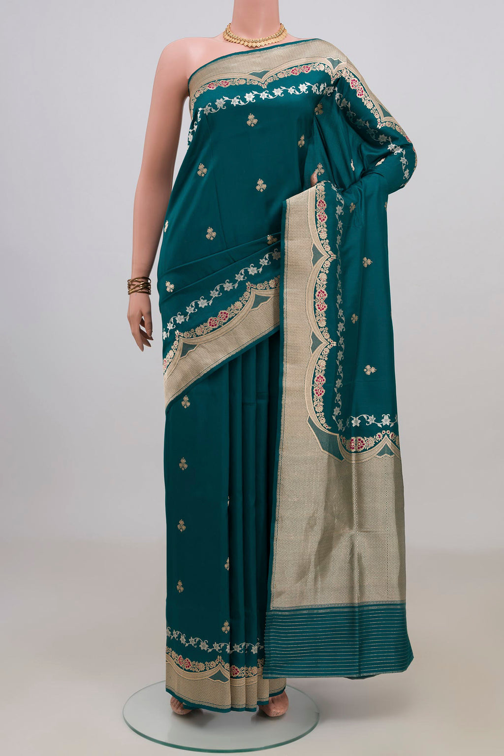 Pure Silk Teal Banarasi Saree with Zari Butta on the body and Fancy Border.  displayed on a mannequin
