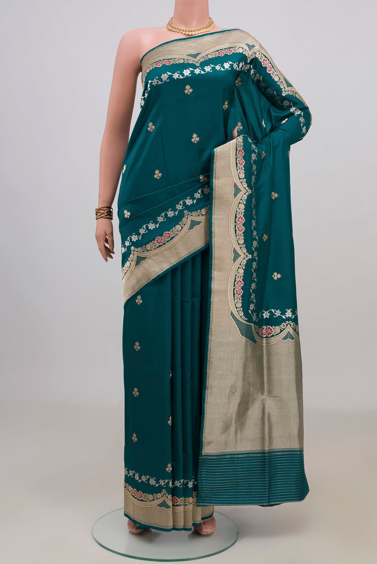 Pure Silk Teal Banarasi Saree with Zari Butta on the body and Fancy Border.  displayed on a mannequin