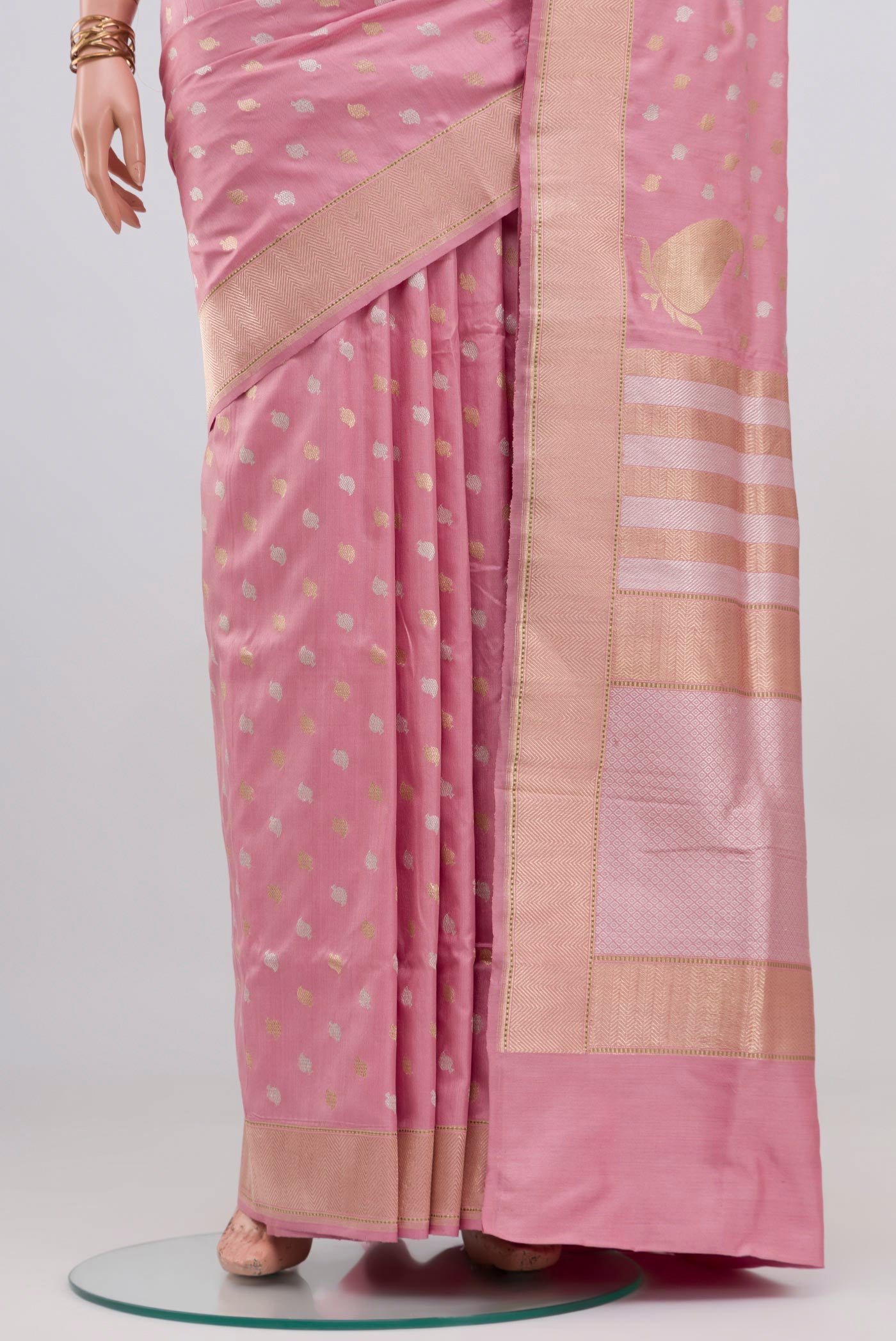 Pleats and pallu of Rose pink Banarasi Silk Saree with Zari Butta on the body and Zari Border. 