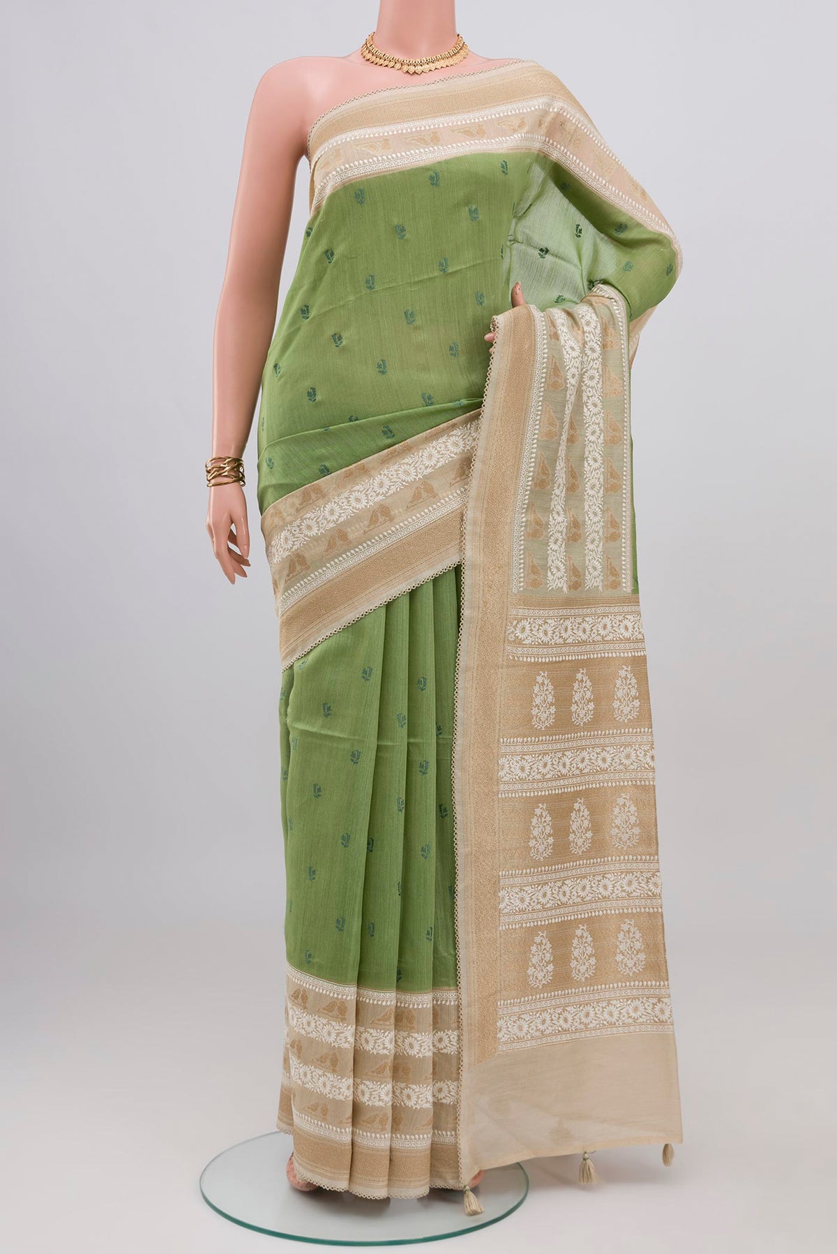 Pista Green Tussar Silk Saree with Embroidery on the body and Zari And Thread Border.  displayed on a mannequin