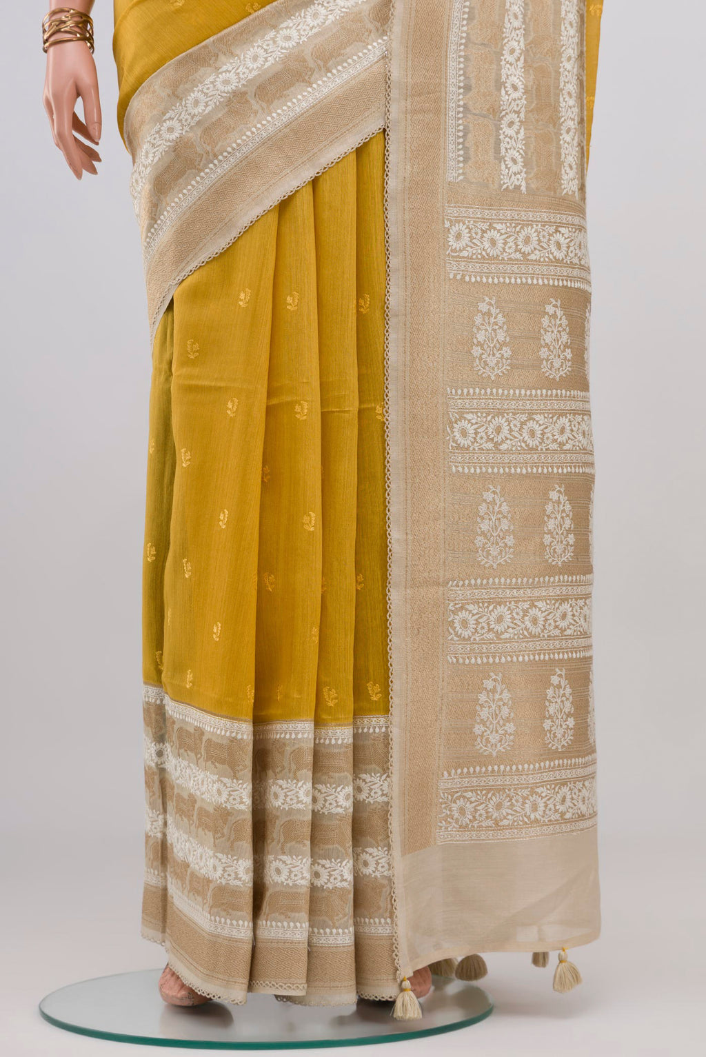 Pleats and pallu of Yellow Tussar Silk Saree with Embroidery on the body and Fancy Border. 