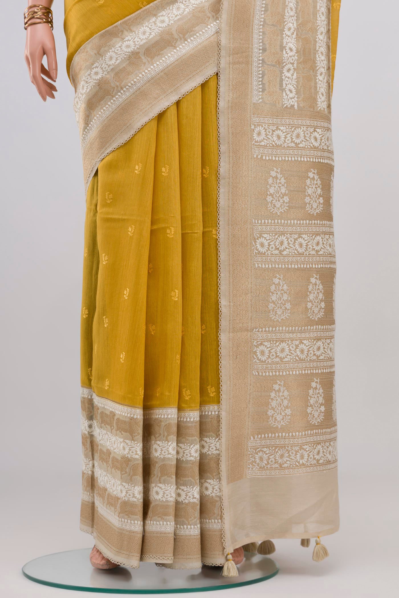 Pleats and pallu of Yellow Tussar Silk Saree with Embroidery on the body and Fancy Border. 