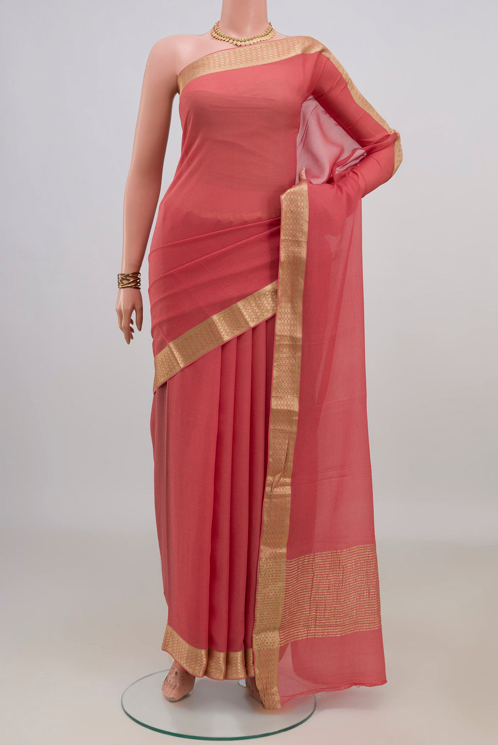 Peach Mysore Chiffon Saree with Plain Body and Zari Border.  displayed on a mannequin