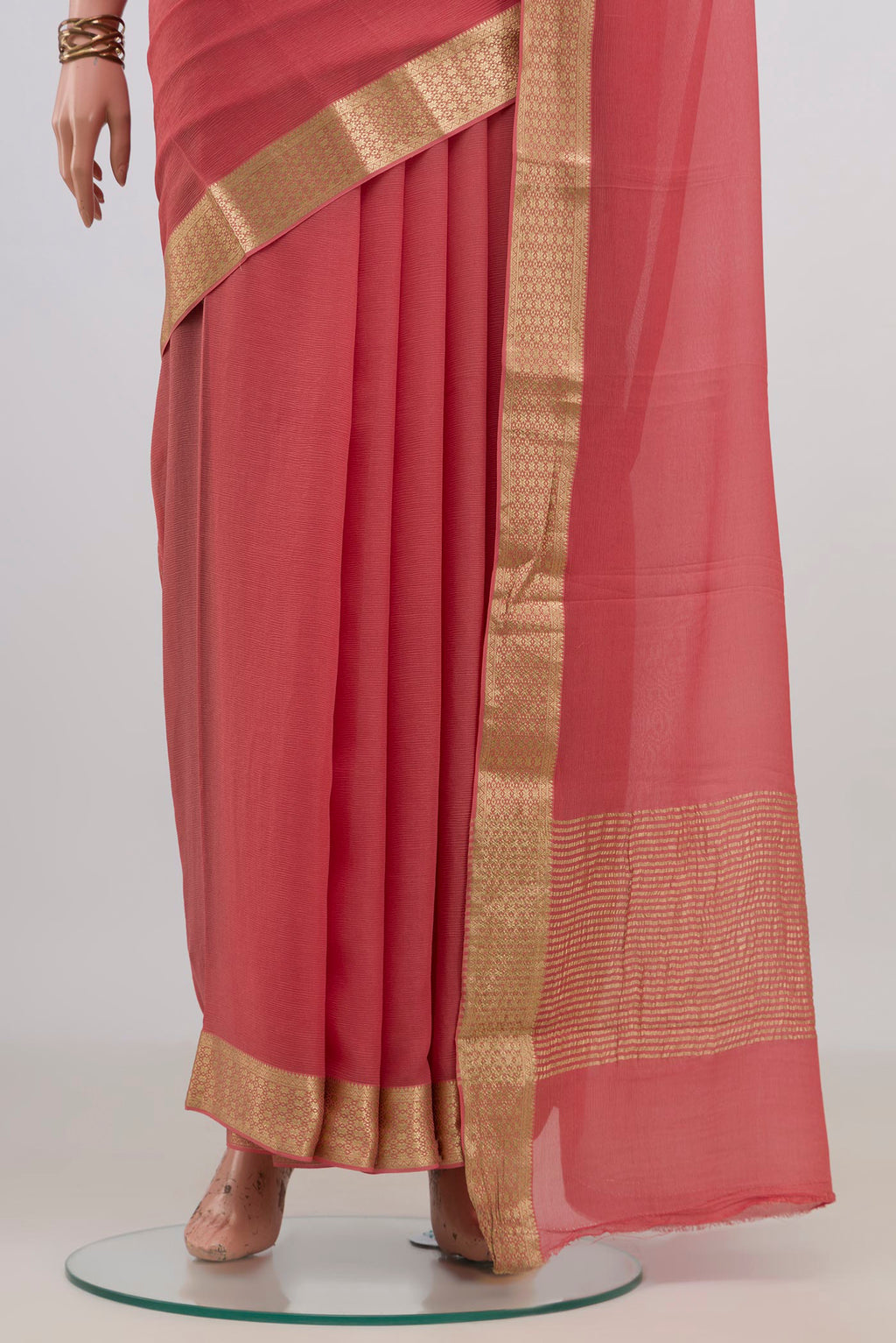 Pleats and pallu of Peach Mysore Chiffon Saree with Plain Body and Zari Border. 