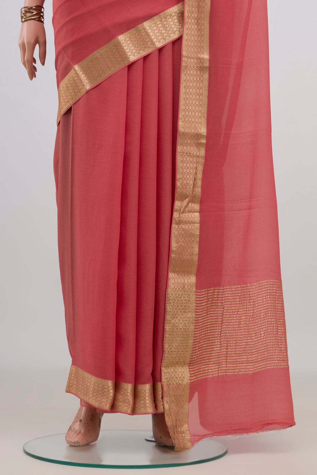 Pleats and pallu of Peach Mysore Chiffon Saree with Plain Body and Zari Border. 